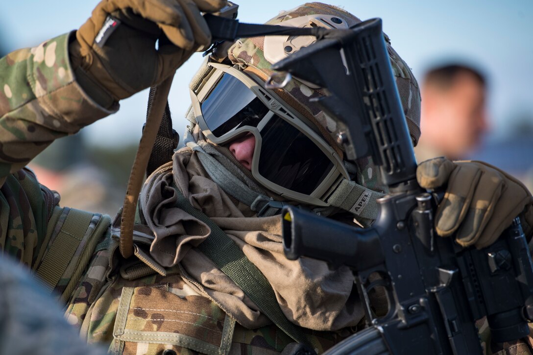 An Airman from the 824th Base Defense Squadron, removes their weapon during a Mission Readiness Exercise, March 16, 2018, at Joint Base McGuire-Dix Lakehurst, N.J. Evaluators tested the 824th BDS from Moody Air Force Base, Ga., and the 105th Security Forces Squadron from Stewart Air National Guard Base, N.Y., to ensure their combat readiness. (U.S. Air Force photo by Senior Airman Janiqua P. Robinson)