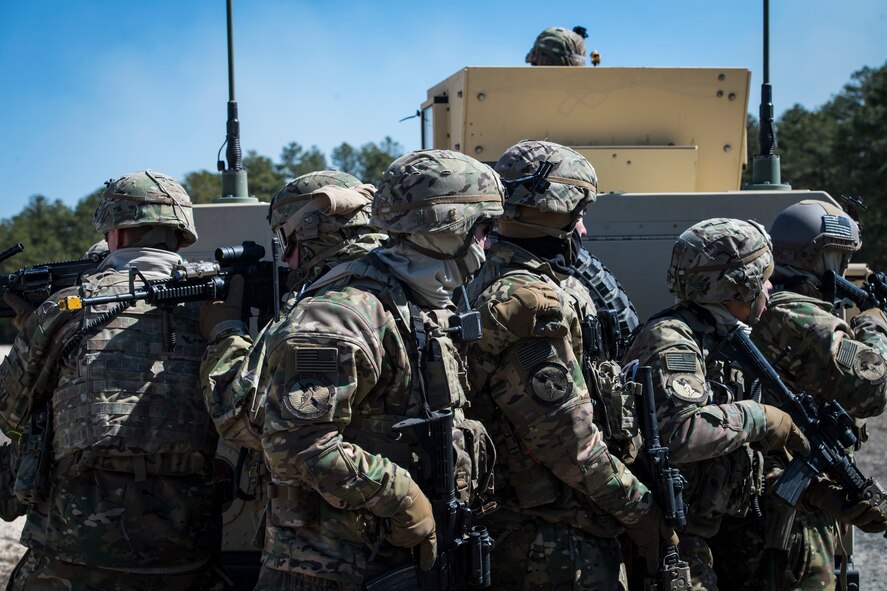 Airmen from the 824th Base Defense Group form up behind a Humvee during a Mission Readiness Exercise, March 13, 2018, at Joint Base McGuire-Dix Lakehurst, N.J. Evaluators tested the 824th BDS from Moody Air Force Base, Ga., and the 105th Security Forces Squadron from Stewart Air National Guard Base, N.Y., to ensure their combat readiness. (U.S. Air Force photo by Senior Airman Janiqua P. Robinson)