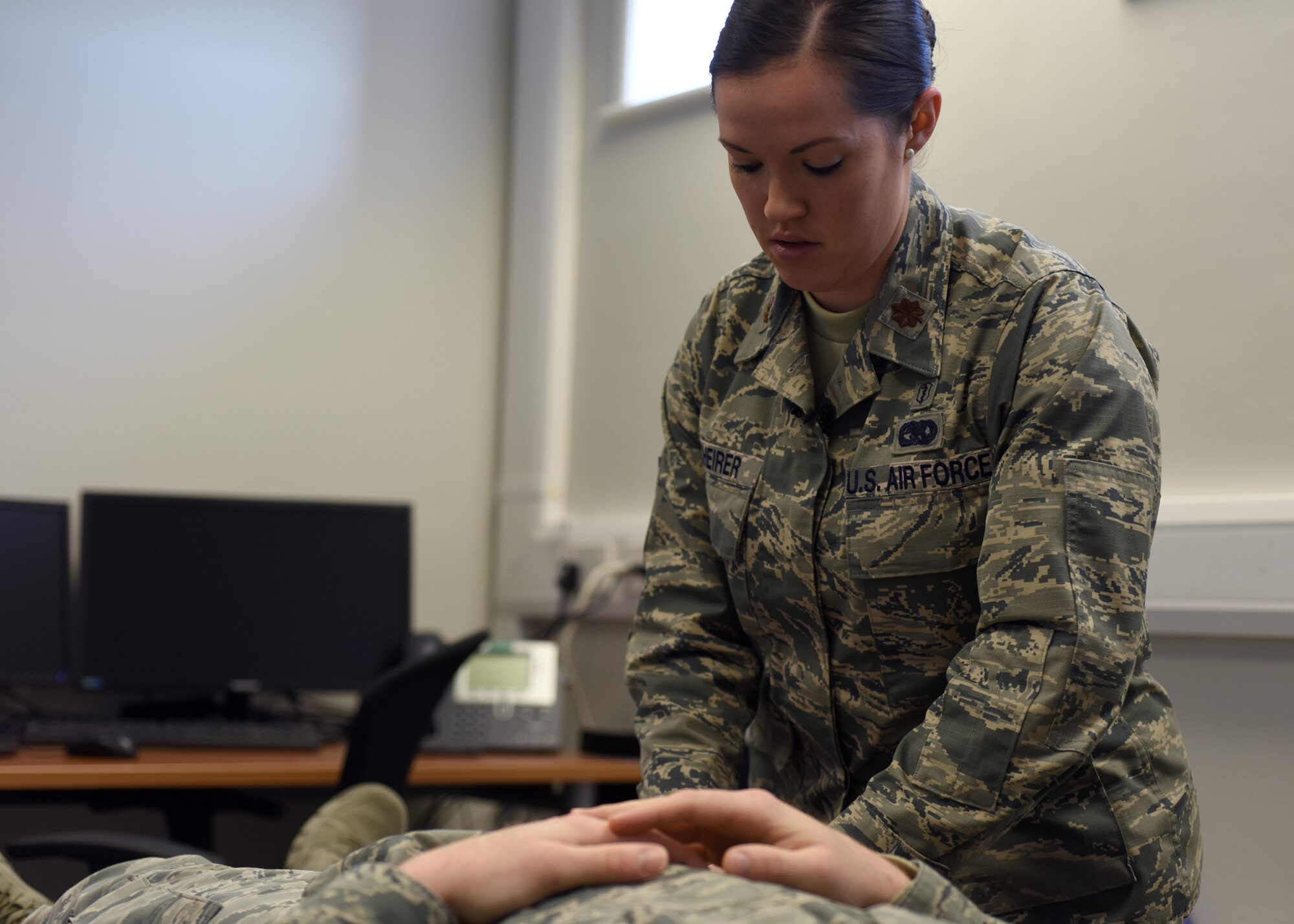 U.S. Air Force Maj. Vanessa Scheirer, 48th Medical Operations Squadron physical therapy element chief, performs an evaluation on a patient at Royal Air Force Lakenheath, England, March 21. The clinic is designed to facilitate easy and quick access to physical care for aircrews. (U.S. Air Force photo/Senior Airman Abby L. Finkel)