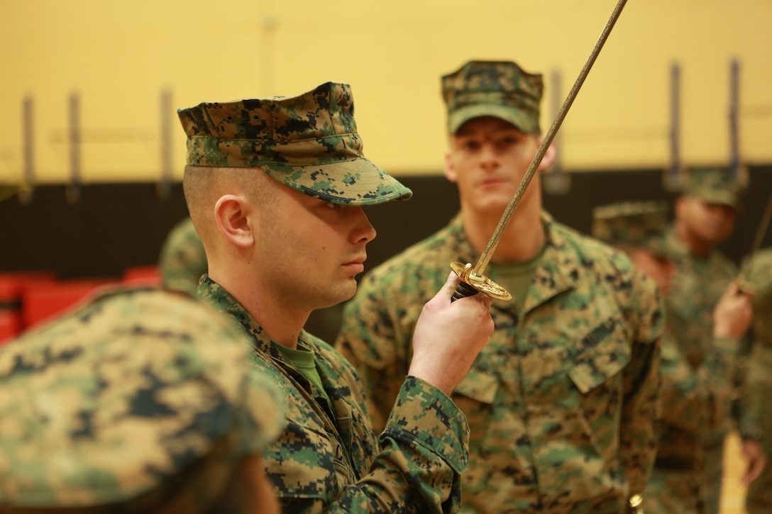 Sgt. Lonnie A. Cooley, instructor, Corporal’s Course 630-18, U.S. Marine Corps Forces Command, demonstrates sword manual at Hopkins Hall Gym aboard Camp Allen, Norfolk, Va., March 21. The instructors demonstrated the proper technique for sword manual to the students in preparation for their test later that week. (Official U.S. Marine Corps photo by Sgt. Mark Tuggle/Released)