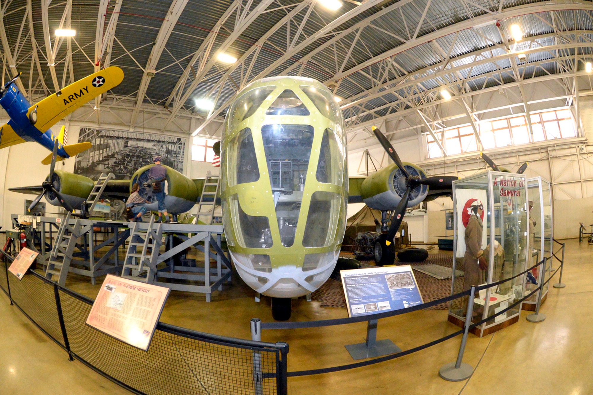 A B-24 Bomber sits on display inside the Hill Aerospace Museum at Hill Air Force Base, Utah, March 13, 2018. The aircraft was in service during World War II, and crashed in the Aleutian Islands of Alaska. It was recovered and restored by the Aerospace Heritage Foundation of Utah. (U.S. Air Force photo by Todd Cromar)