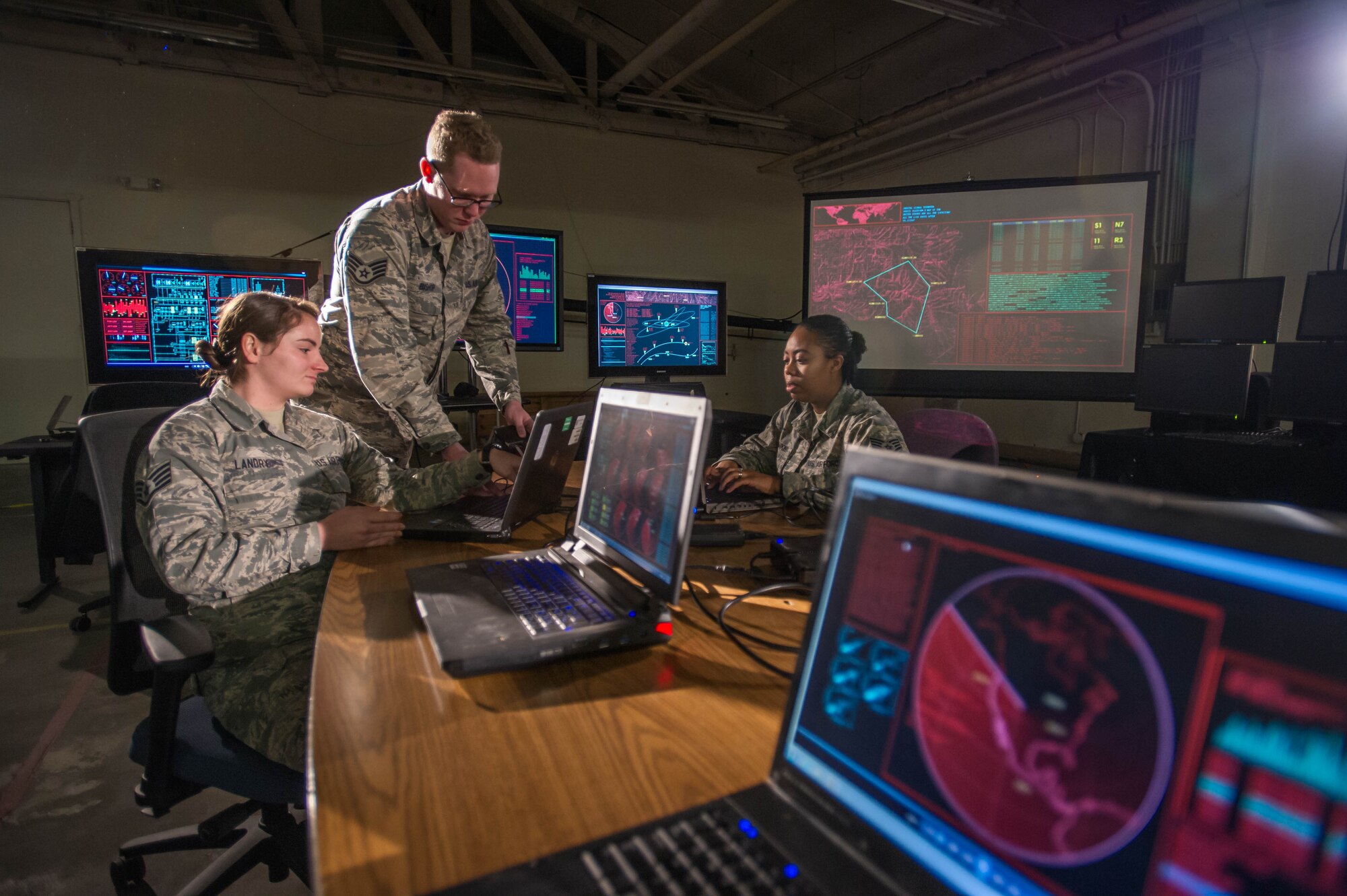 Members of the 2nd Audiovisual Squadron Cyber Maintenance and Support Flight prepare more than 20 computers to suport the filming of an Air Force Space Command production, "Space Superiority." (U.S. Air Force photo by Jon Zanone)