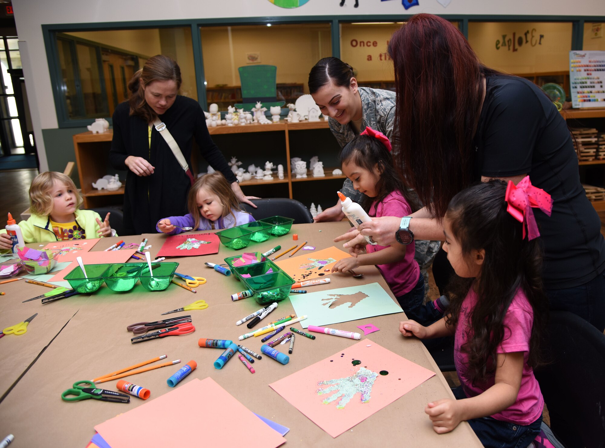 Keesler children and their mothers decorate a hand cut-out during an arts and crafts session at the McBride Commons March 21, 2018, on Keesler Air Force Base, Mississippi. Keesler children and their mothers attended the event which was held in recognition of Women’s History Month. A luncheon will also be held to remember women’s history March 27 at the Bay Breeze Event Center. (U.S. Air Force photo by Kemberly Groue)