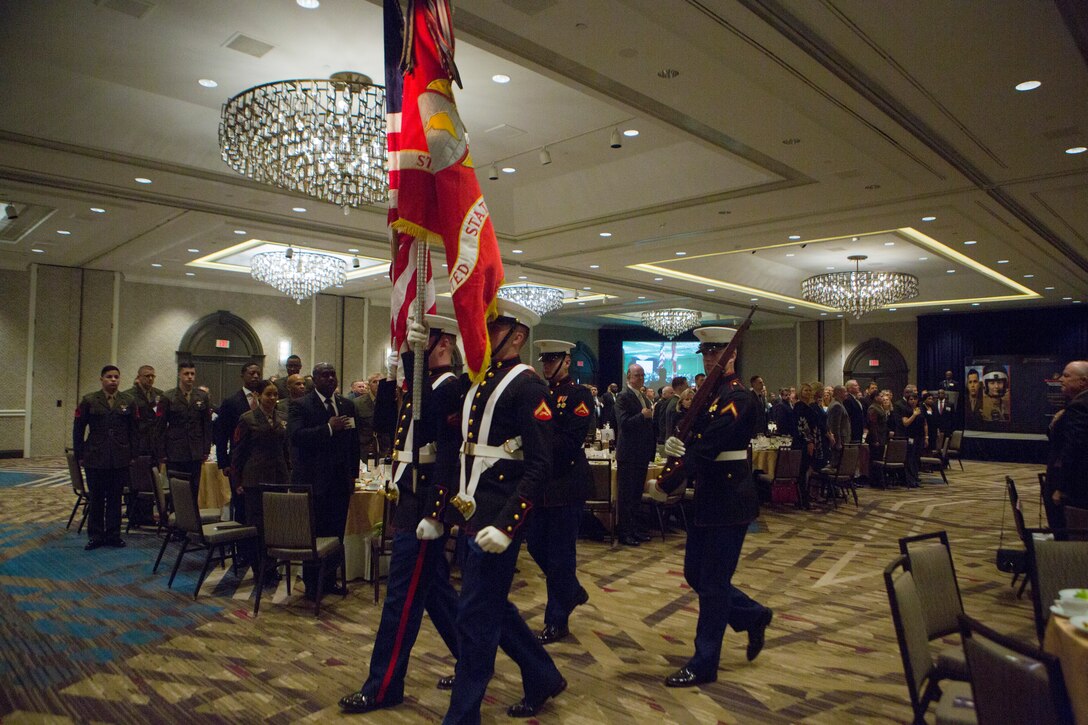 A color guard exits the auditorium after the playing of To The Colors during the opening ceremony of the Marine Corps Association and Foundation's 14th annual Ground Logistics Awards Dinner at the Crystal Gateway Marriott, Arlington, Virginia, March 22, 2018. The dinner provides the formal opportunity to recognize the professional achievements of the top performing Marine logisticians and logistics unit of the year for the previous year. (U.S. Marine Corps photo by Cpl. Dallas Johnson)