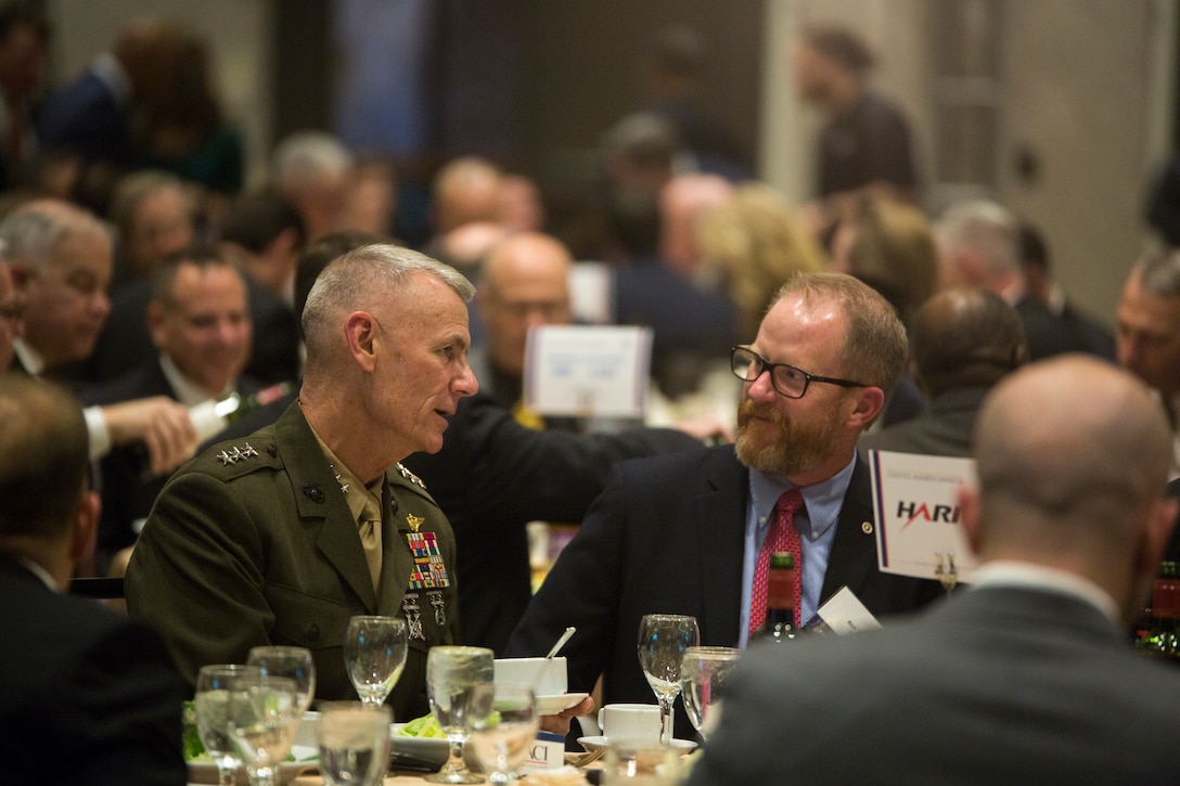 Lt. Gen. Rex C. McMillian, commander of Marine Forces Reserve and Marine Forces North, talks with an attendee at the Marine Corps Association and Foundation's 14th annual Ground Logistics Awards Dinner at the Crystal Gateway Marriott, Arlington, Virginia, March 22, 2018. Competing against every logistics unit in the Marine Corps, Reserve unit Marines Wing Support Squadron 473 has, for the first time in the awards history, won the Marine Corps Logistics Organization/Team of the Year for a large unit award for all their humanitarian and relief efforts with hurricane's Harvey and Irma, as well as aide relief for a plane crash in Mississippi. (U.S. Marine Corps photo by Cpl. Dallas Johnson)