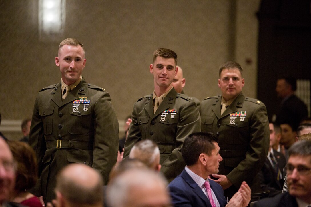 Marines with Marine Wing Support Squadron 473 stand to show they were the winners of Marine Corps Logistics Organization/Team of the Year for a large unit award before the opening ceremony of the Marine Corps Association and Foundation's 14th annual Ground Logistics Awards Dinner at the Crystal Gateway Marriott, Arlington, Virginia, March 22, 2018. MWSS-473 was given the award in part for their hurricane relief efforts and their aide efforts when Marine Aerial Refueler Transport Squadron 452 crashed in Mississippi. (U.S. Marine Corps photo by Cpl. Dallas Johnson)
