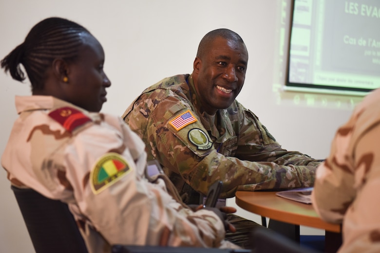 Capt. Malick Traore, 818th Mobility Support Advisory Squadron aeromedical evacuation project manager, discusses principles of altitude physiology and stresses of flight with a Malian chief of medical operation during African Partnership Flight Senegal, March 20, 2018. Partnership flights are U.S. Air Forces Africa’s premier security cooperation program with African partner nations to improve professional military aviation knowledge and skills. (U.S. Air Force photo by Capt. Kay Magdalena Nissen)