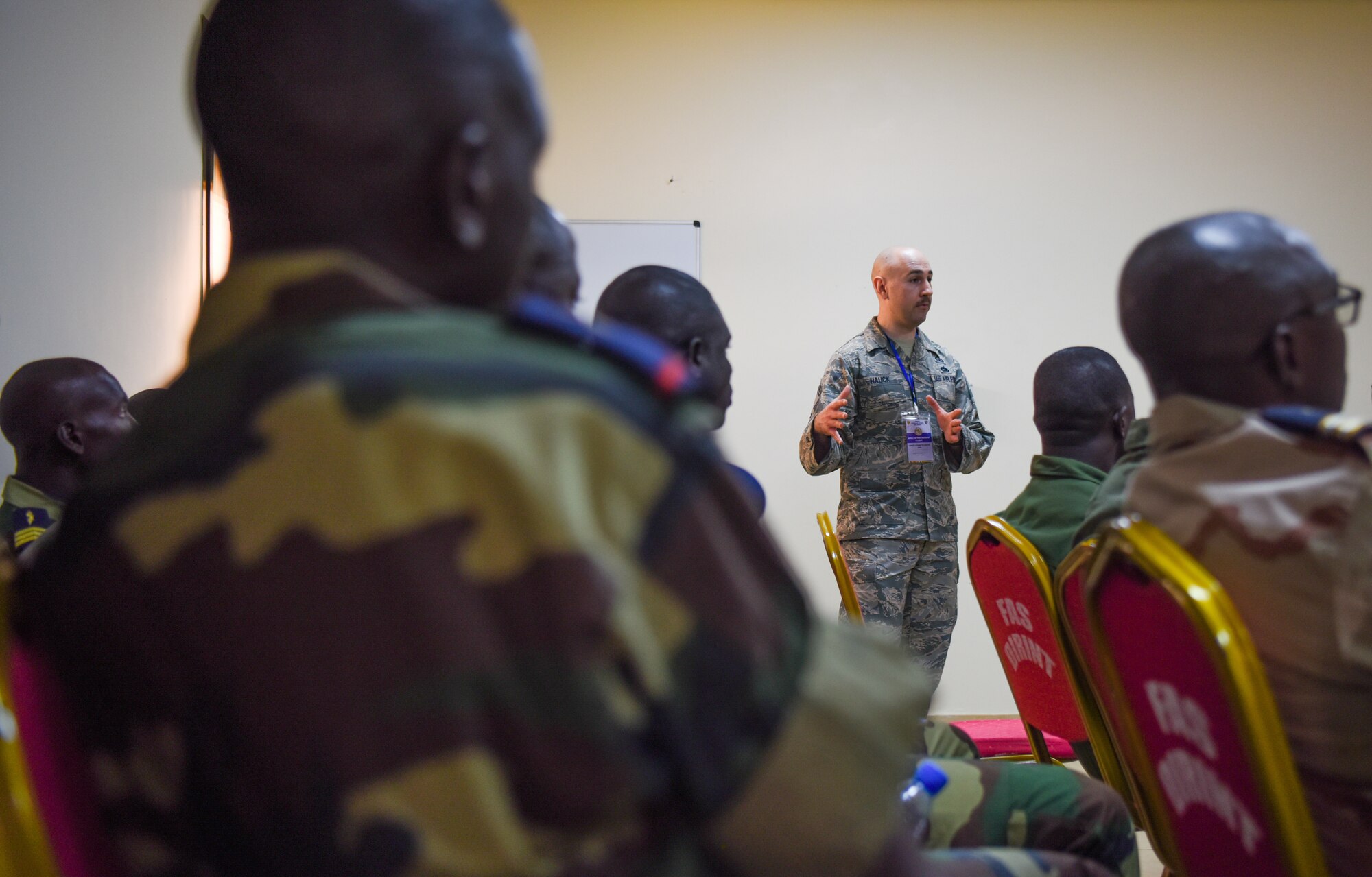 Chief Master Sgt. Ken Hauck, 48th Fighter Wing staff agencies superintendent, answers questions during an air and ground safety group discussion during African Partnership Flight Senegal at Captain Andalla Cissé Air Base, Senegal, March 20, 2018. APF Senegal involves approximately 40 U.S. Airmen from U.S. Air Forces in Europe and Air Forces Africa, the West Virginia Air National Guard, the 818th Mobility Support Advisory Squadron, and the Language Enabled Airman Program. (U.S. Air Force photo by Capt. Kay Magdalena Nissen)