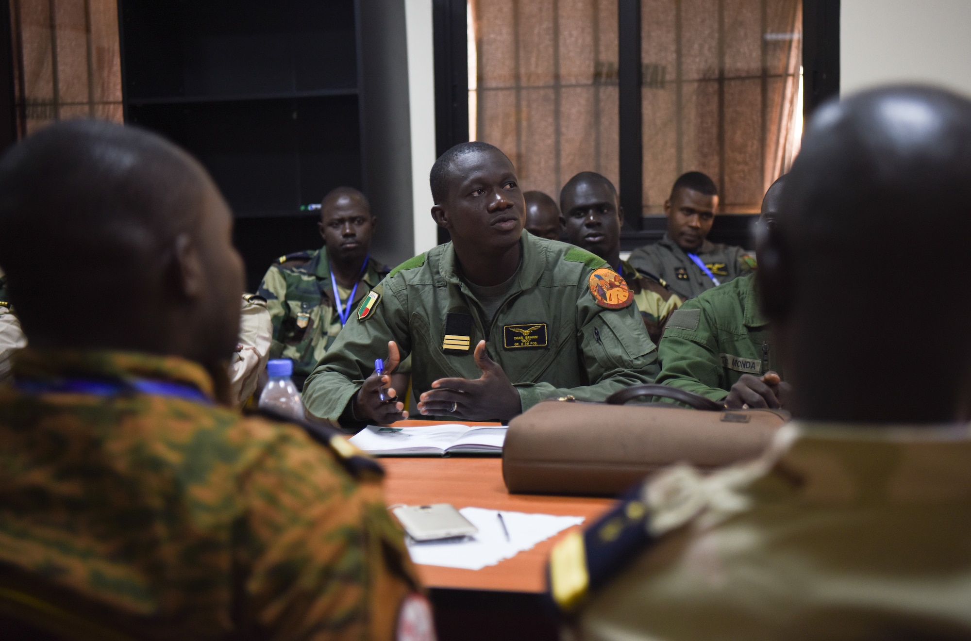 Benin helicopter pilot, Capt. Chabi Ibrahim, discusses safety in air operations during African Partnership Flight Senegal at Captain Andalla Cissé Air Base, Senegal, March 20, 2018. APF Senegal is a multilateral, military-to-military engagement emphasizing security assistance with African air forces. (U.S. Air Force photo by Capt. Kay Magdalena Nissen)
