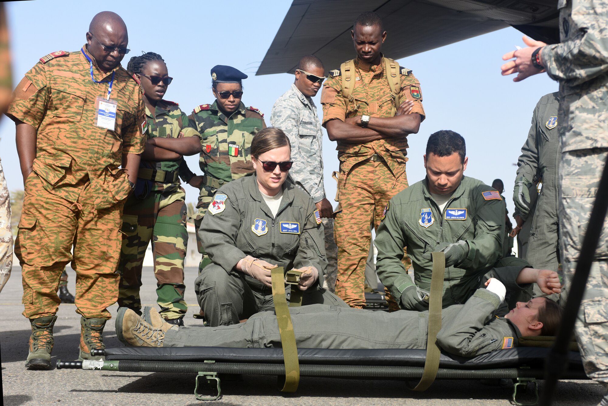 West Virginia Air National Guard medical technicians, assigned to the 167th Aeromedical Evacuation Squadron, demonstrate how to load a patient onto a litter at Captain Andalla Cissé Air Base, Senegal, March 22, 2018. The demonstration was part of African Partnership Flight Senegal, an event co-hosted by the U.S. and Senegal that focuses on the exchange of knowledge in the aeromedical and casualty evacuation fields, as well as air and ground safety. (U.S. Air Force photo by Airman 1st Class Eli Chevalier)