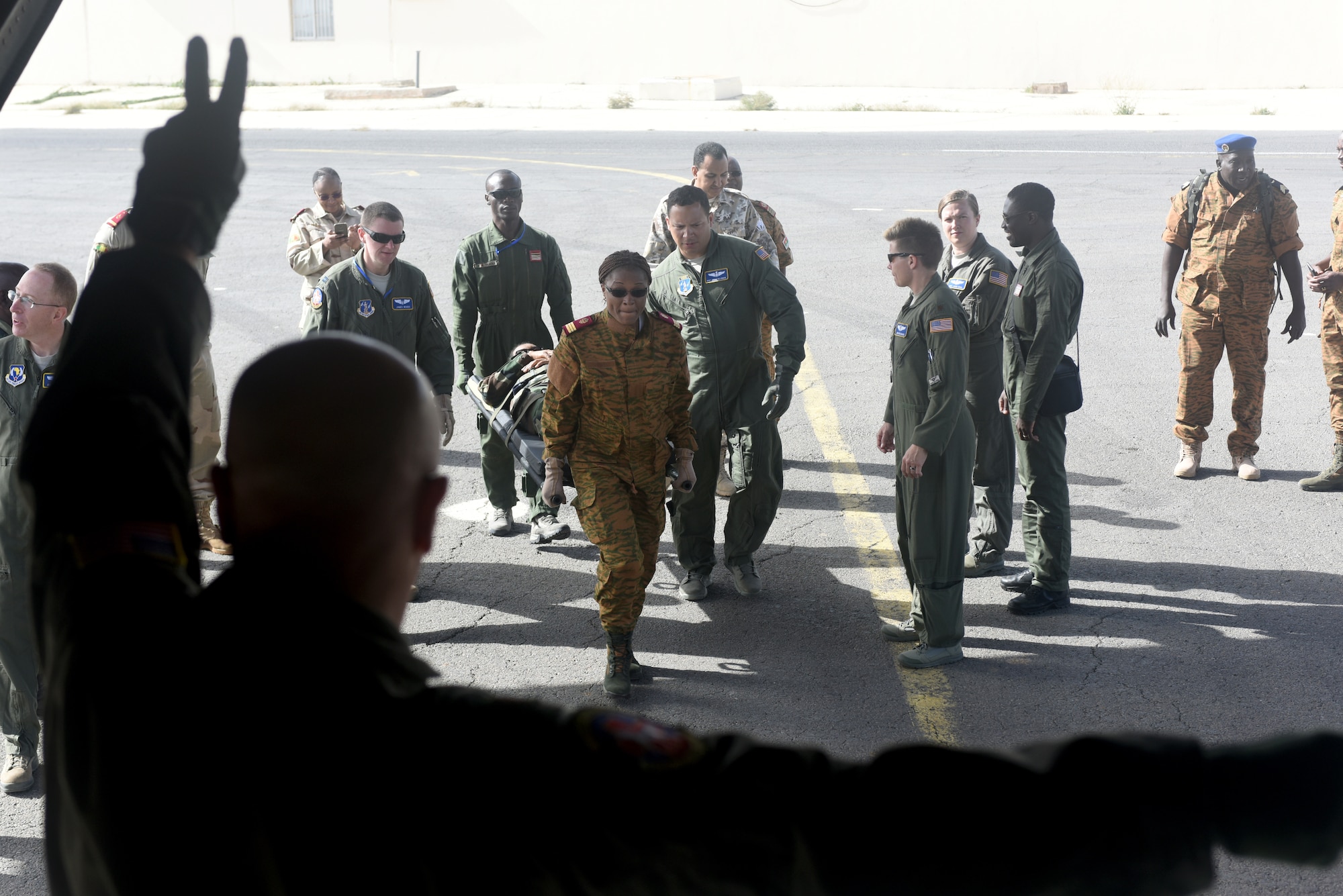 Participants of African Partnership Flight Senegal load patients onto a West Virginia Air National Guard C-130H Hercules at Captain Andalla Cissé Air Base, Senegal, March 19. The purpose of APF is to conduct multilateral, military-to-military engagements and security assistance with African air forces. (U.S. Air Force photo by Airman 1st Class Eli Chevalier)