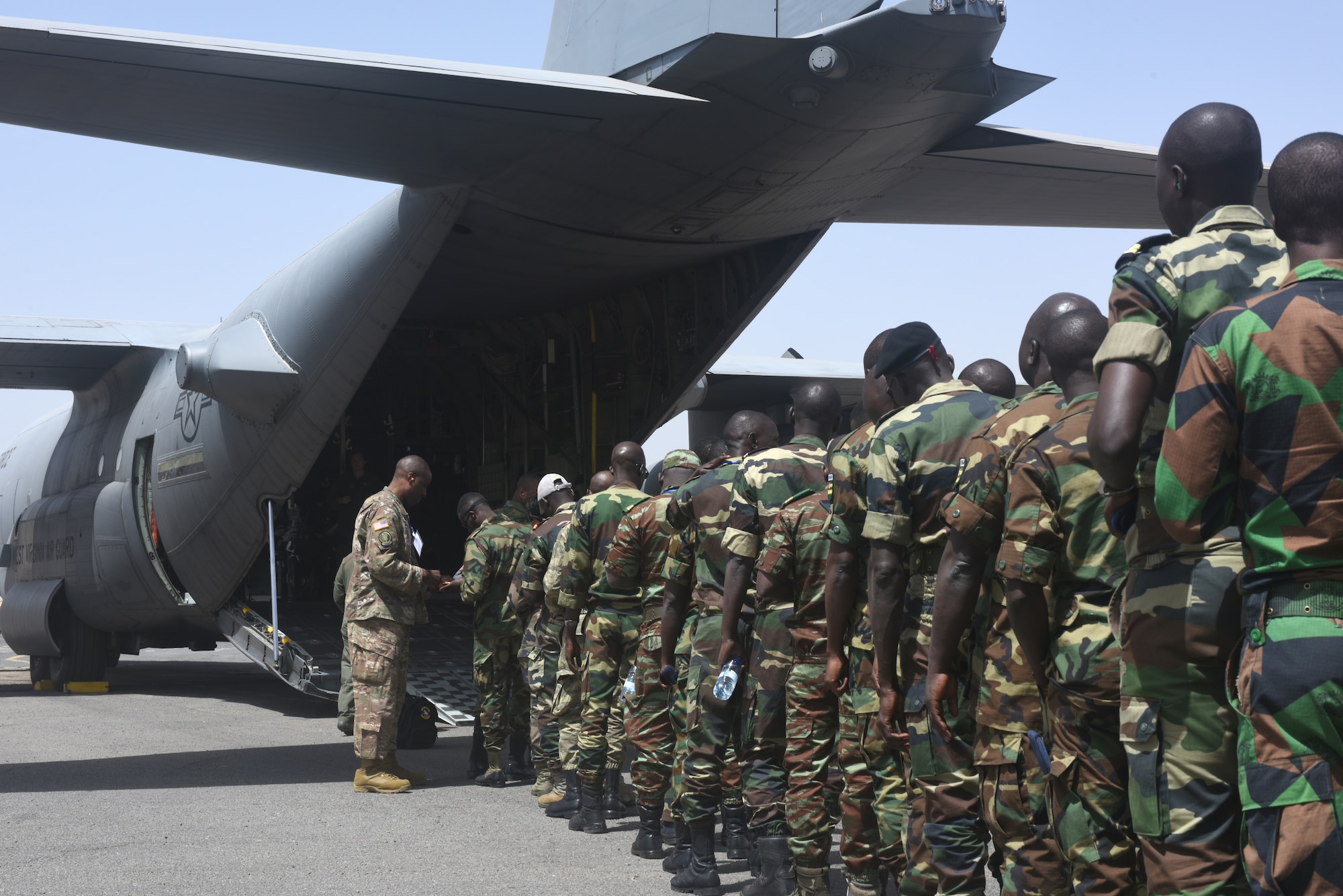 Participants of African Partnership Flight Senegal prepare to board a C-130H Hercules, assigned to the 130th Airlift Wing, West Viginia Air National Guard, at Captain Andalla Cissé Air Base, Senegal, March 22, 2018. The APF program is U.S. Air Forces Africa’s premier security cooperation program with African partner nations to improve professional military aviation knowledge and skills. (U.S. Air Force photo by Airman 1st Class Eli Chevalier)