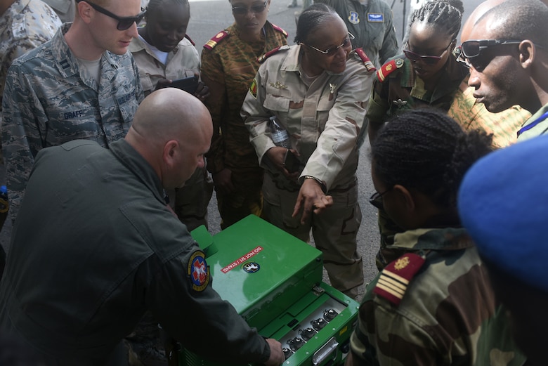 Chief Master Sgt. Matt Lyons, 167th Aeromedical Evacuation Squadron medical technician, explains the liquid oxygen system used onboard C-130H Hercules aircraft at Captain Andalla Cissé Air Base, Senegal, March 22, 2018. The 186th AES is in Dakar in support of African Partnership Flight Senegal, a military-to-military event co-hosted by Senegal and the U.S. focusing on casualty evacuation, aeromedical evacuation and air and ground safety. (U.S. Air Force photo by Airman 1st Class Eli Chevalier)