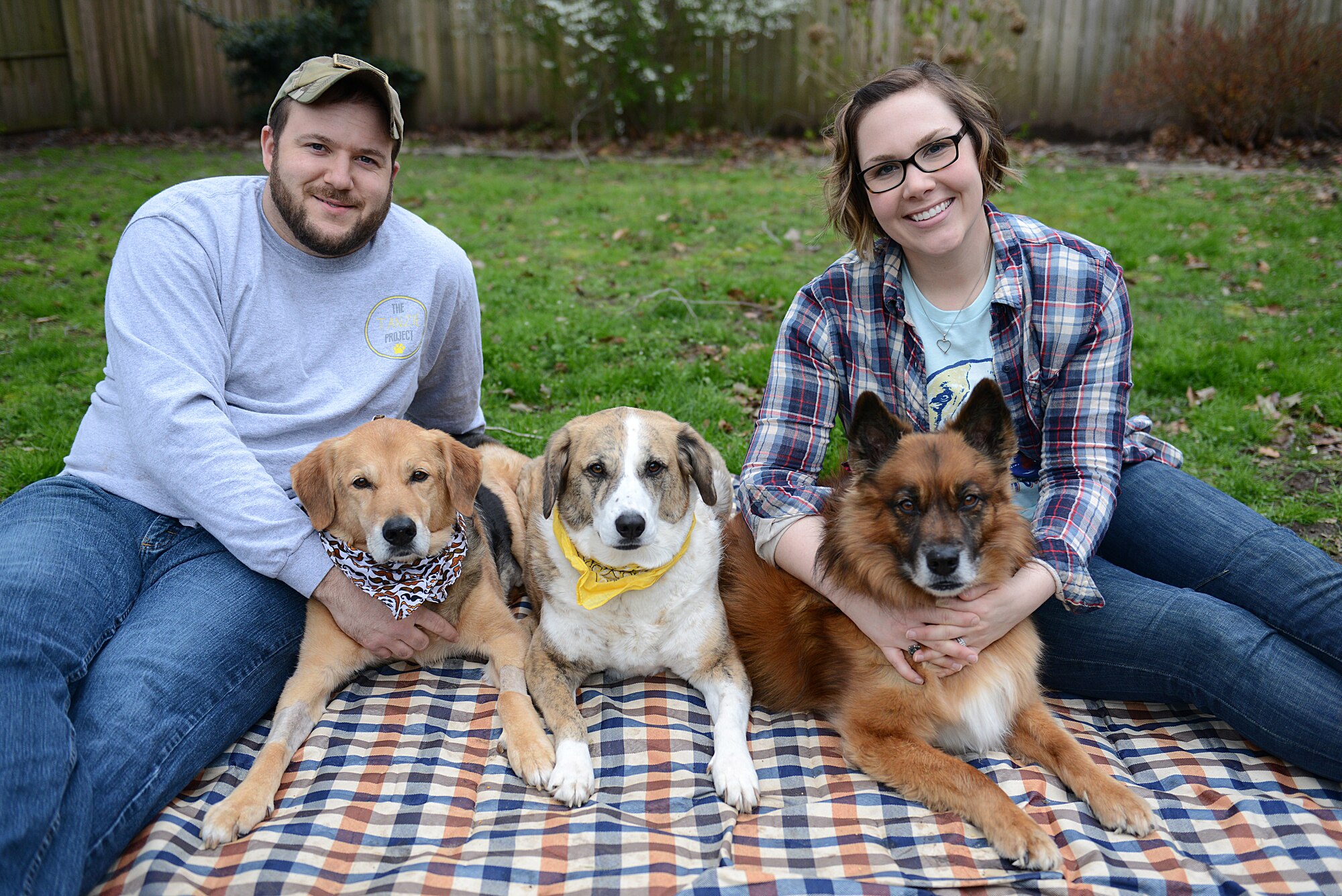 Walker Ward, former U.S. Air Force Security Forces Squadron patrolman, and his wife, Tech. Sgt. Katie Ward, 633rd Air Base Wing Public Affairs media operations NCO in charge pose for a photo with their dogs Benji, Tanzie and Bella, in Hampton, Virginia, March 8, 2018.