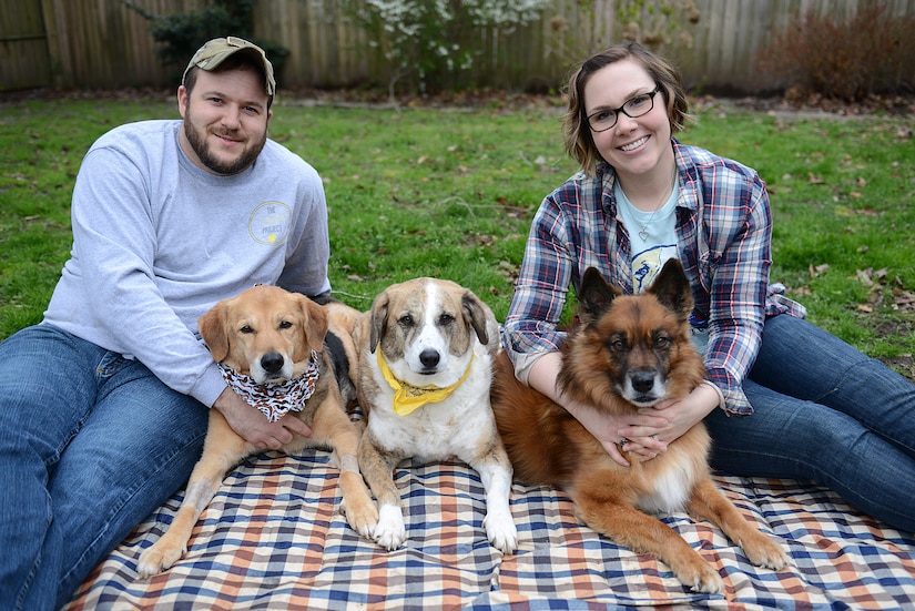 Walker Ward, former U.S. Air Force Security Forces Squadron patrolman, and his wife, Tech. Sgt. Katie Ward, 633rd Air Base Wing Public Affairs media operations NCO in charge pose for a photo with their dogs Benji, Tanzie and Bella, in Hampton, Virginia, March 8, 2018.