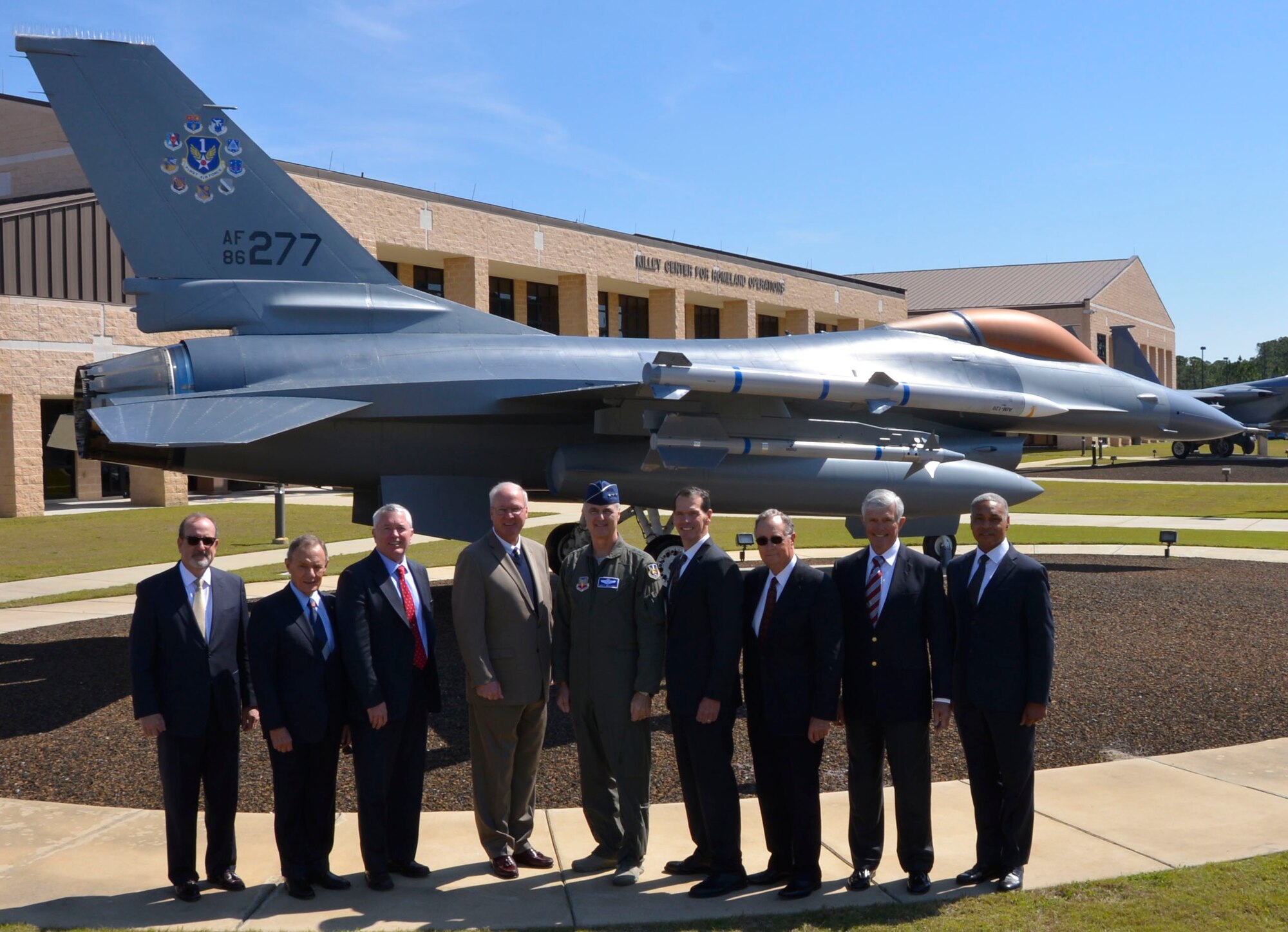 Eight former 1st Air Force commanders flank the current  1st AF Commander, Lt. Gen. R. Scott Williams, for a photo opportunity with the 1st Air Force F-16 Fighting Falcon March 13. The leaders were here for the “Evolution of 1st Air Force Commander’s Forum,” held March 13-14, which brought together eight previous 1st Air Force commanders, from 1994 to the present, for a discussion on how their previous command experience lessons could enhance the success of both current and future enterprise operations.  (Air Force Photo by Mary McHale)