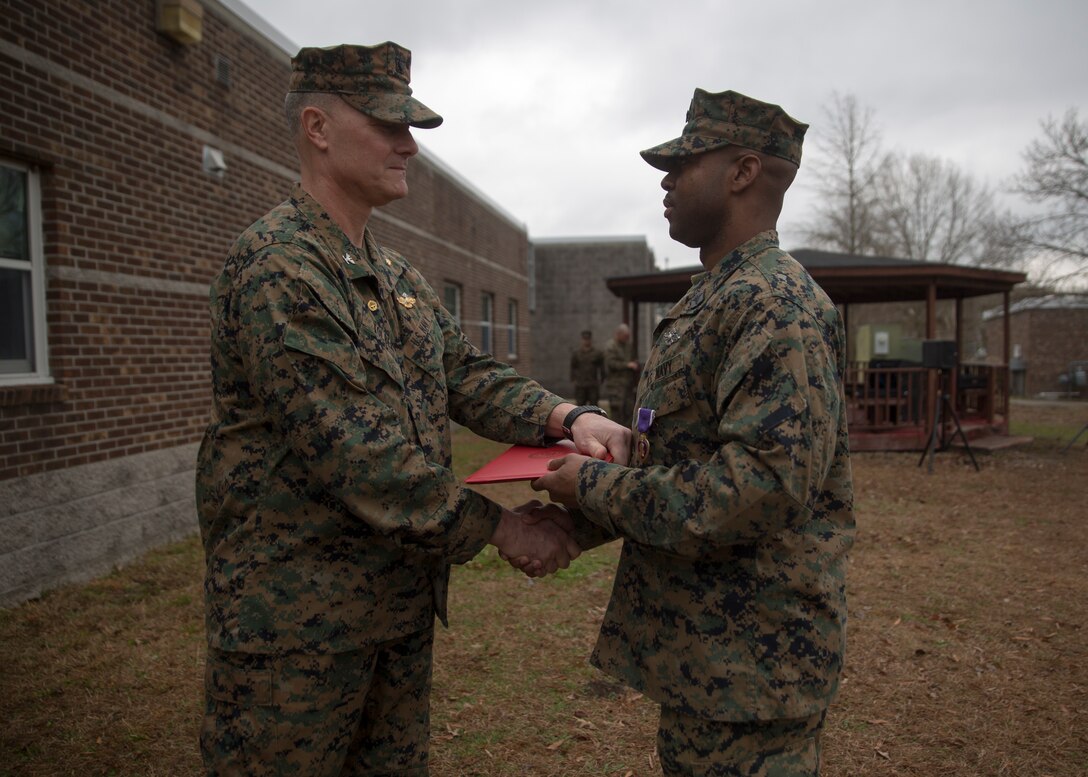 Capt. Brian Tolbert, the commanding officer of 2nd Medical Battalion, 2nd Marine Logistics Group, awards Petty Officer 2nd Class Willie Jones, a corpsman with 2nd Med. Bn., a Purple Heart during an award ceremony at Camp Lejeune N.C., Feb. 8, 2018. Jones was awarded the Purple Heart for injuries sustained from a vehicle borne improvised explosive device in Afghanistan, Sept. 6 2017. Despite his own injuries, Jones provided aid for injured service members when a VBIED detonated during a patrol. (U.S. Marine Corps photo by Cpl. Victoria Ross)
