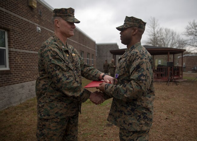 Capt. Brian Tolbert, the commanding officer of 2nd Medical Battalion, 2nd Marine Logistics Group, awards Petty Officer 2nd Class Willie Jones, a corpsman with 2nd Med. Bn., a Purple Heart during an award ceremony at Camp Lejeune N.C., Feb. 8, 2018. Jones was awarded the Purple Heart for injuries sustained from a vehicle borne improvised explosive device in Afghanistan, Sept. 6 2017. Despite his own injuries, Jones provided aid for injured service members when a VBIED detonated during a patrol