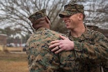 A Marine congratulates Petty Officer 2nd Class Willie Jones, a corpsman with 2nd Medical Battalion, 2nd Marine Logistics Group, after a Purple Heart award ceremony at Camp Lejeune N.C., Feb. 8, 2018. Jones was awarded the Purple Heart for injuries sustained from a vehicle borne improvised explosive device in Afghanistan, Sept. 6 2017. Despite his own injuries, Jones provided aid for injured service members when a VBIED detonated during a patrol. (U.S. Marine Corps photo by Cpl. Victoria Ross)