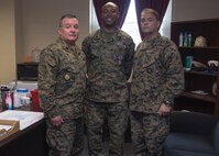 Master Chief Petty Officer Juan Lopez, left, the command master chief of 2nd Medical Battalion, 2nd Marine Logistics Group, and Master Chief Petty Officer Russell Folley, right, the command master chief of 2nd Marine Division, pose with Petty Officer 2nd Class Willie Jones, center, a corpsman with 2nd Med. Bn., for a photo at the conclusion of a Purple Heart award ceremony at Camp Lejeune N.C., Feb. 8, 2018. Jones was awarded the Purple Heart for injuries sustained from a vehicle borne improvised explosive device in Afghanistan, Sept. 6 2017. Despite his own injuries, Jones provided aid for injured service members when a VBIED detonated during a patrol. (U.S. Marine Corps photo by Cpl. Victoria Ross)