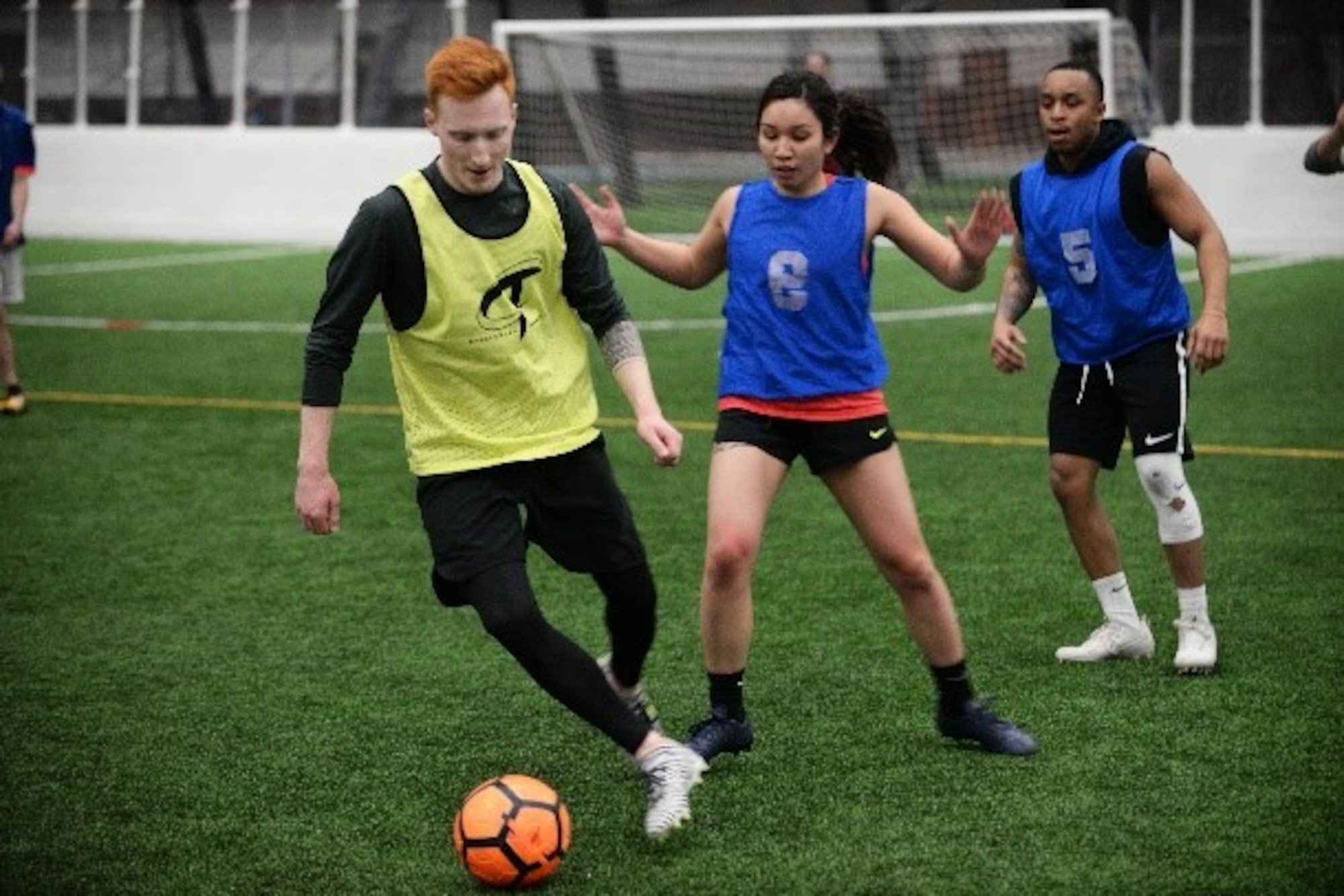 Airman 1st Class Rylee Boyd-jablonski, left, a 28th Communication Squadron knowledge management technician, keeps a soccer ball away from defenders at Ellsworth Air Force Base, S.D., March 7, 2018. Intramural sports provide an outlet for Airmen to stay active and socialize with others around the base. (U.S. Air Force photo by Airman 1st Class Thomas Karol)