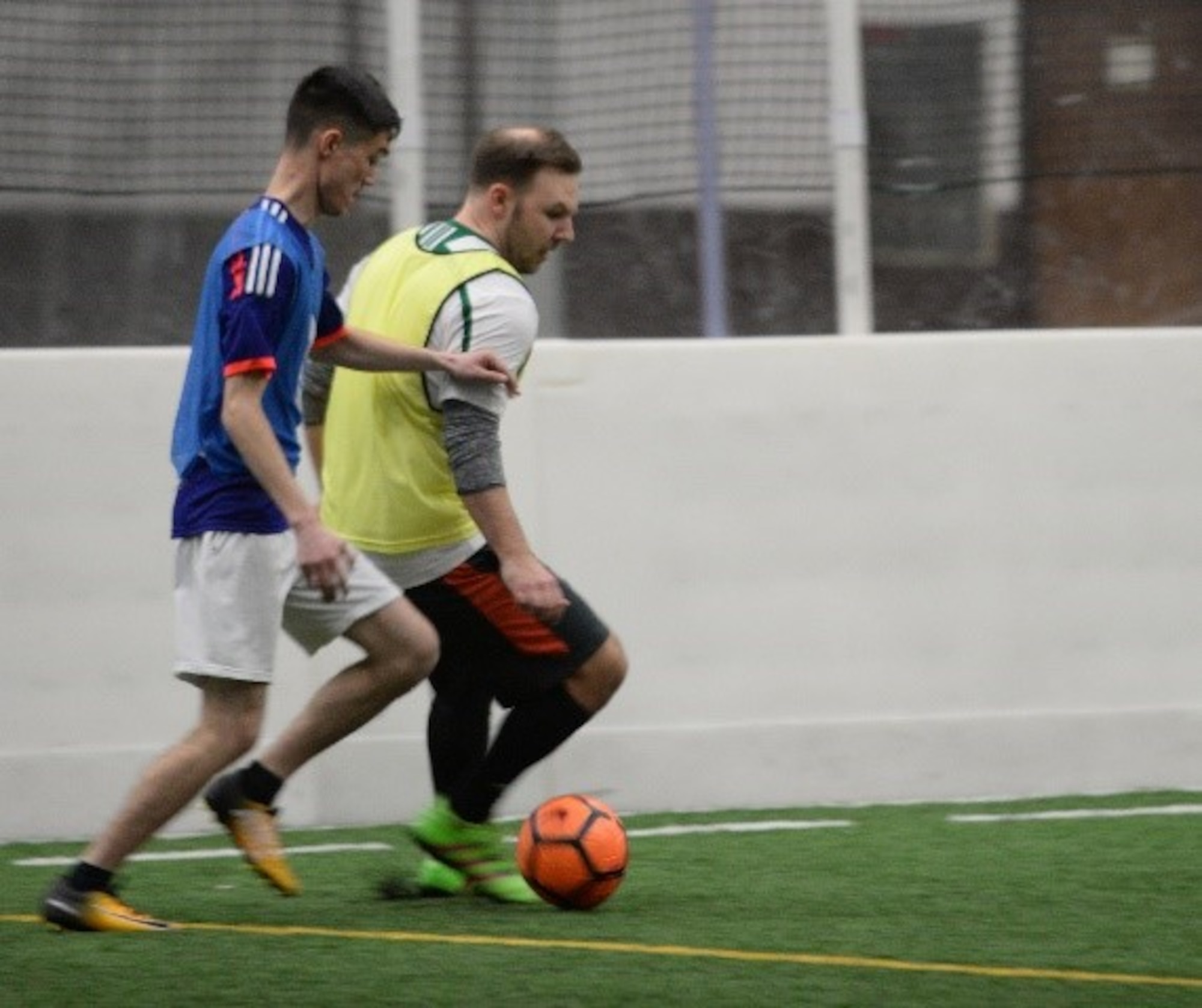 Senior Airman Jordan Combs, a 28th Bomb Wing administration journeyman, dribbles a soccer ball past a defender at Ellsworth Air Force Base, S.D., March 7, 2018. Intramural sports provide an outlet for Airmen to stay active and socialize with others around the base. (U.S. Air Force photo by Airman 1st Class Thomas Karol)