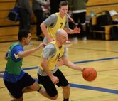 Airman 1st Class Joseph Chambers, a 28th Operations Support Squadron air traffic controller apprentice, moves past a defender on his way down the basketball court at Ellsworth Air Force Base, S.D., Dec. 6, 2017. Intramural sports provide an outlet for Airmen to stay active and socialize with others around the base. (U.S. Air Force photo by Airman 1st Class Thomas Karol)