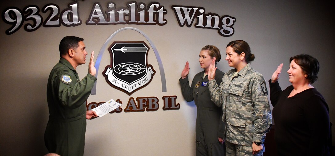 The newest members of the 932nd Airlift Wing's Wing Inspection Team take their oath as inspectors with the commander, Col. Raymond Smith, on March 21, 2018, at Scott Air Force Base, Ill.  They will help improve the unit by identifying programs to correct to help execute the mission.  (U.S. Air Force photo by Lt. Col. Stan Paregien)