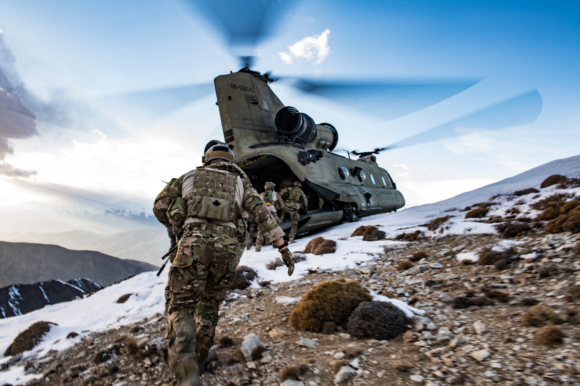 Air Force pararescuemen, assigned to the 83rd Expeditionary Rescue Squadron, work with members of Army Task Force Brawler, flying the CH-47F Chinook, during exfiltration after the completion of a training exercise at Bagram Airfield, Afghanistan, March 14, 2018. The Army crews and Air Force Guardian Angel teams conducted the exercise to build teamwork and procedures as they provide joint personnel recovery capability, aiding in the delivery of decisive airpower for U.S. Central Command. (U.S. Air Force Photo by Tech. Sgt. Gregory Brook)