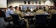 People in a conference around a table.