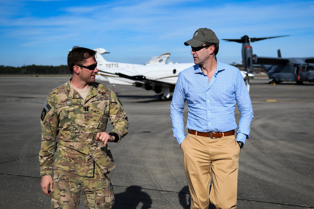 Two people engaged in conversation on a flight line