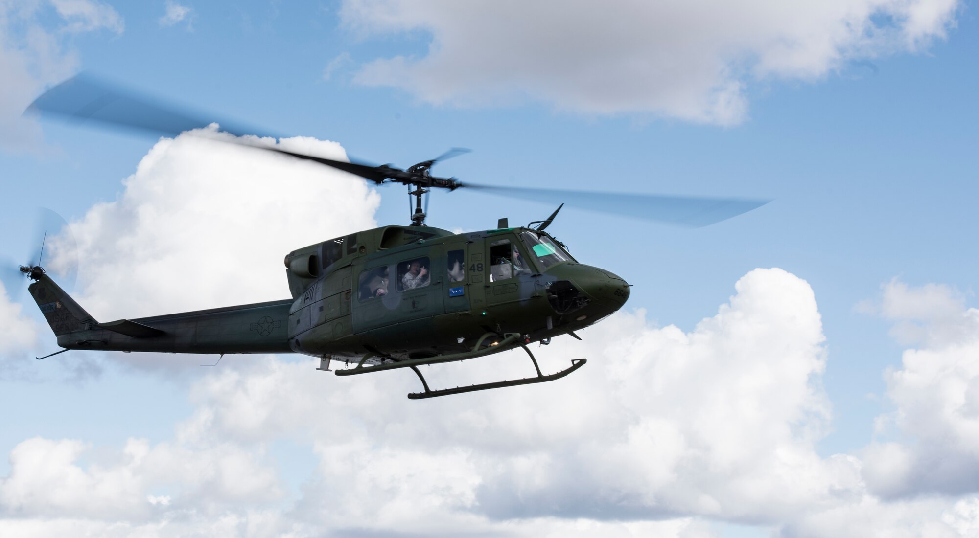 Lt. Gen. GI Tuck, 18th Air Force commander, participates in a UN-H1 Huey flight during a mission immersion March 19, 2018, at Fairchild Air Force Base, Washington. Tuck and his team visited Airmen in their work environments to discuss their goals, priorities and expectations for the 18th AF team. (U.S. Air Force photo/Senior Airman Sean Campbell)