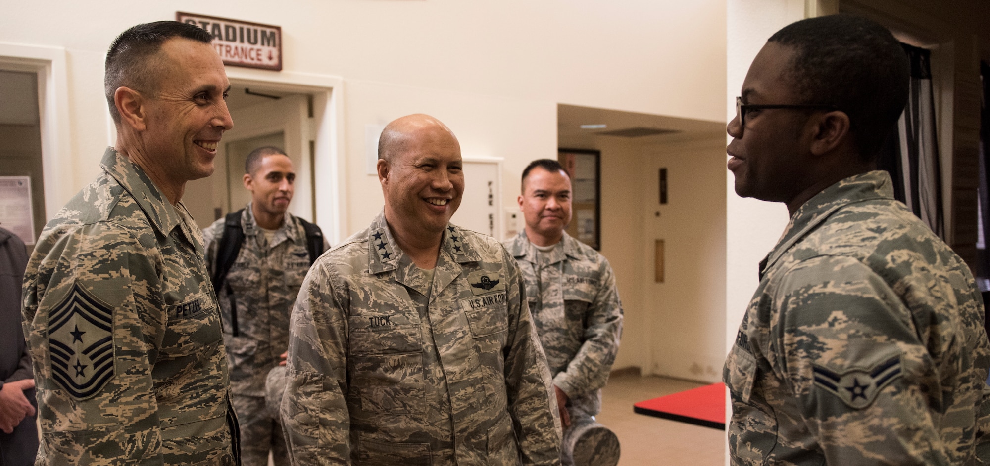 Lt. Gen. GI Tuck, 18th Air Force commander, and Chief Master Sgt. Todd Petzel, 18th AF command chief, talk with Airman Dorm Council representatives while touring the Airmen dorm campus March 20, 2018, at Fairchild Air Force Base, Washington. The visit familiarized 18th Air Force leadership with the Fairchild mission and the Airmen who make it happen. (U.S. Air Force photo/Senior Airman Sean Campbell)