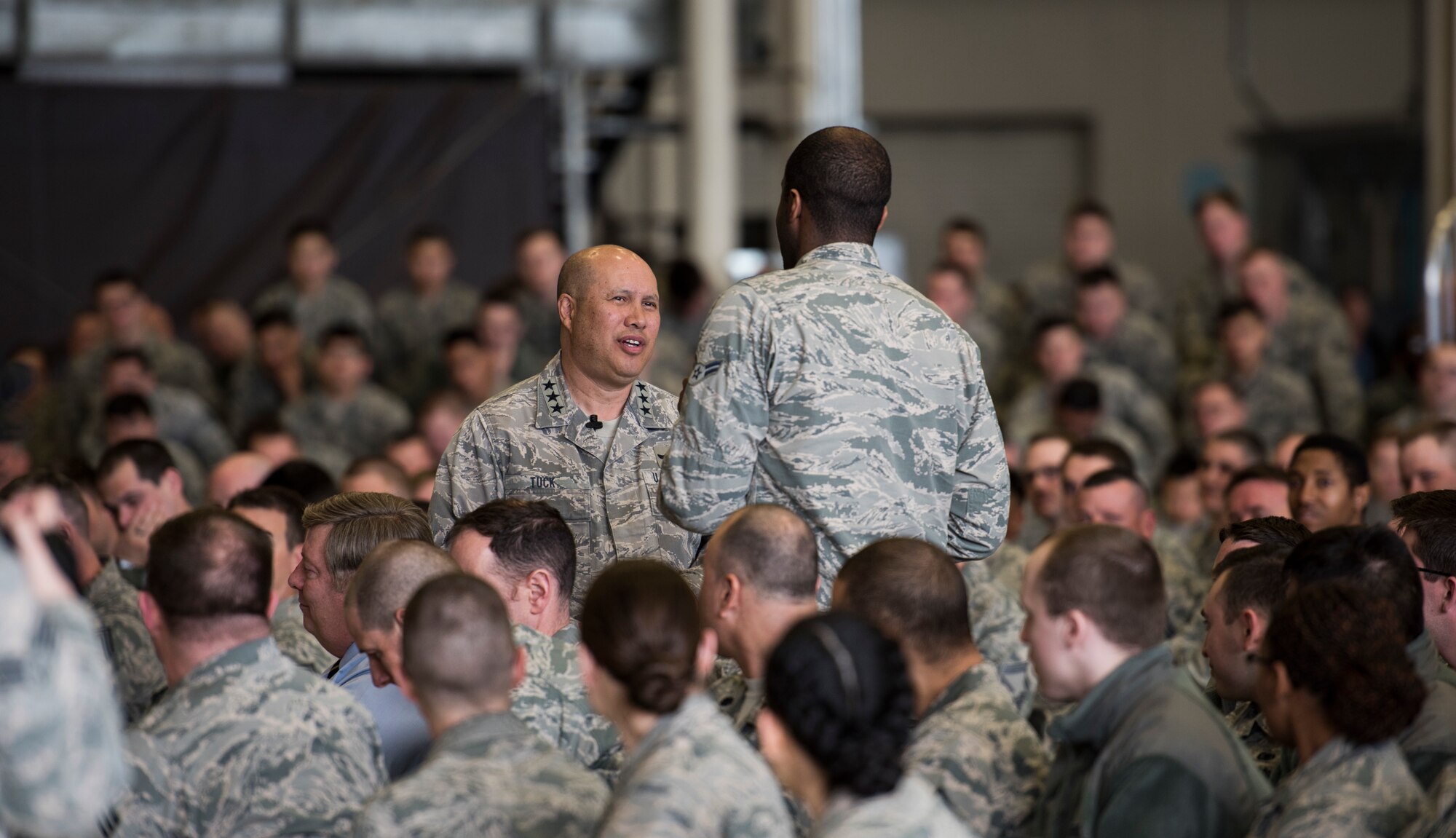 Lt. Gen. GI Tuck, 18th Air Force commander, answers questions during a base all call March 21, 2018, at Fairchild Air Force Base, Washington. Tuck spoke about the importance of working with joint forces and multi-domain command and control. (U.S. Air Force photo/Senior Airman Sean Campbell)