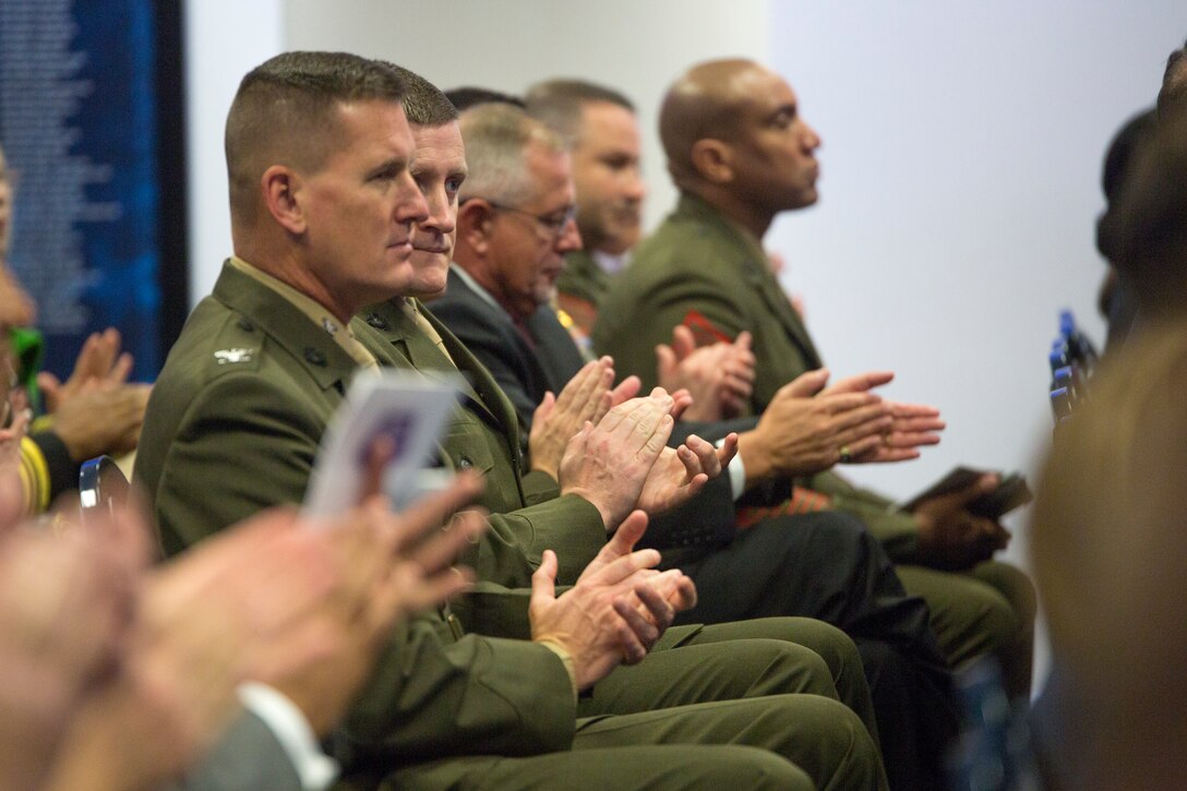 Marines with Combat Logistics Battalion 451, 4th Marine Logistics Group, Marine Forces Reserve, clap as Lt. Gen. Rex C. McMillian, commander of Marine Forces Reserve and Marine Forces North, walks to the stage to talk about the accomplishments made by CLB-451 in 2017, at the Pentagon's Hall of Heroes, Arlington, Virginia, March 23, 2018. Established in 2000, the Department of Defense Reserve Family Readiness Award recognizes the top unit in each of the seven Reserve components, which are a vital link in the support networks for Reserve component families. (U.S. Marine Corps photo by Cpl. Dallas Johnson)