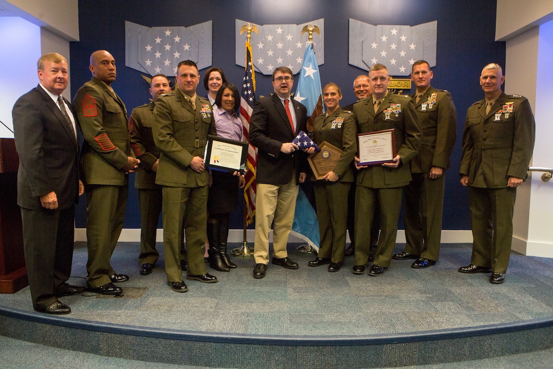 Lt. Gen. Rex C. McMillian (right), commander of Marine Forces Reserve and Marine Forces North, poses with Marines with Combat Logistics Battalion 451, 4th Marine Logistics Group, Marine Forces Reserve, after they receive the 2017 Department of Defense Family Readiness Award, at the Pentagon's Hall of Heroes, Arlington, Virginia, March 23, 2018. Established in 2000, the DoD Reserve Family Readiness Award recognizes the top unit in each of the seven Reserve components, which are a vital link in the support networks for Reserve component families. (U.S. Marine Corps photo by Cpl. Dallas Johnson)