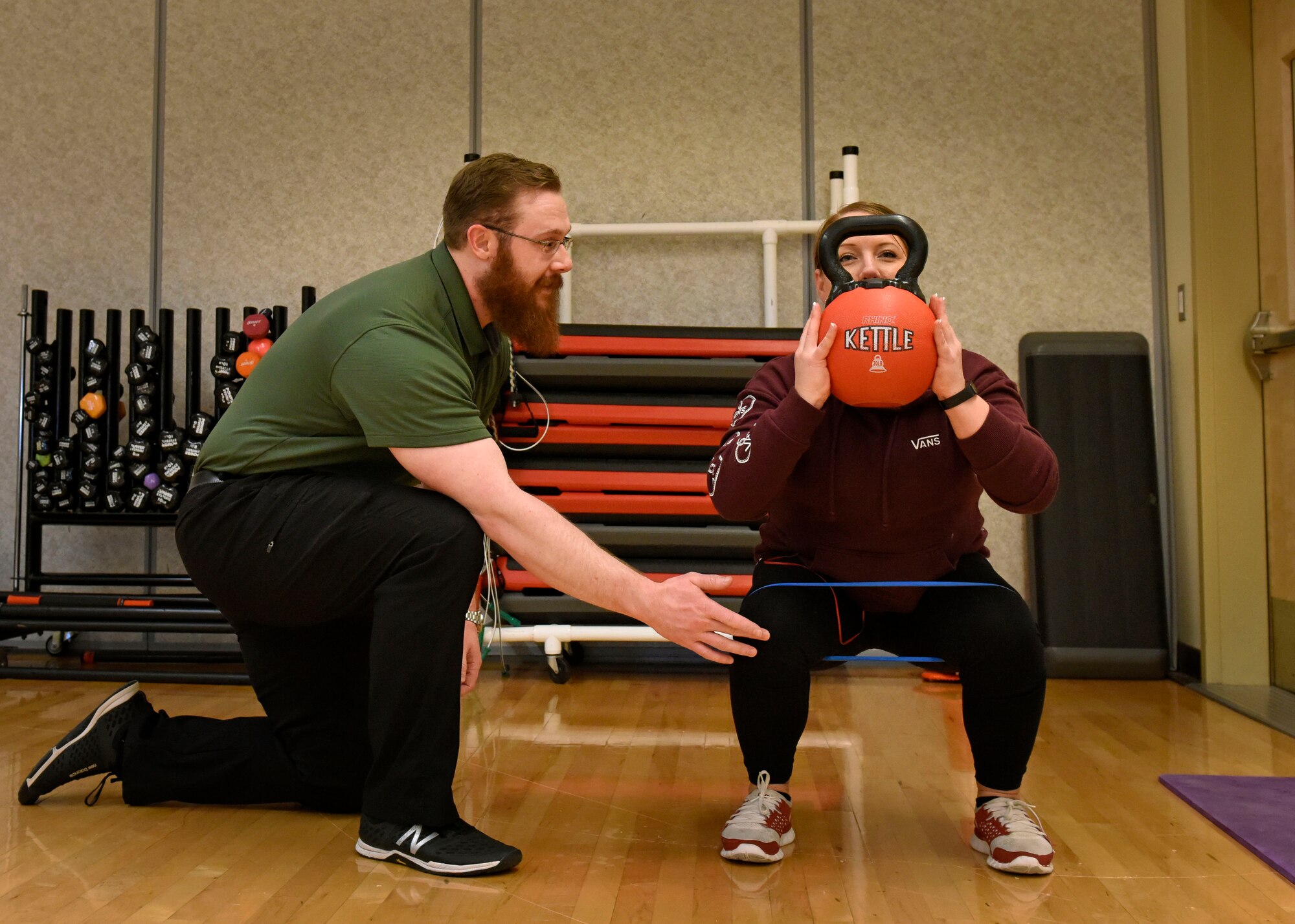 Justin Clifford, 92nd Medical Operations Squadron physical therapist, assists Staff Sgt. Jamie Skrainka, 92nd Maintenance Squadron Human Performance Cell patient, with a weighted squat at Fairchild Air Force Base, Washington, Feb. 21, 2018. Clifford is a part of a multi-disciplinary team in the HPC program that focuses on transitioning Airmen from being non-deployable to deployable, by helping them gain the strength and endurance required for success. (U.S. Air Force photo/Airman 1st Class Jesenia Landaverde)