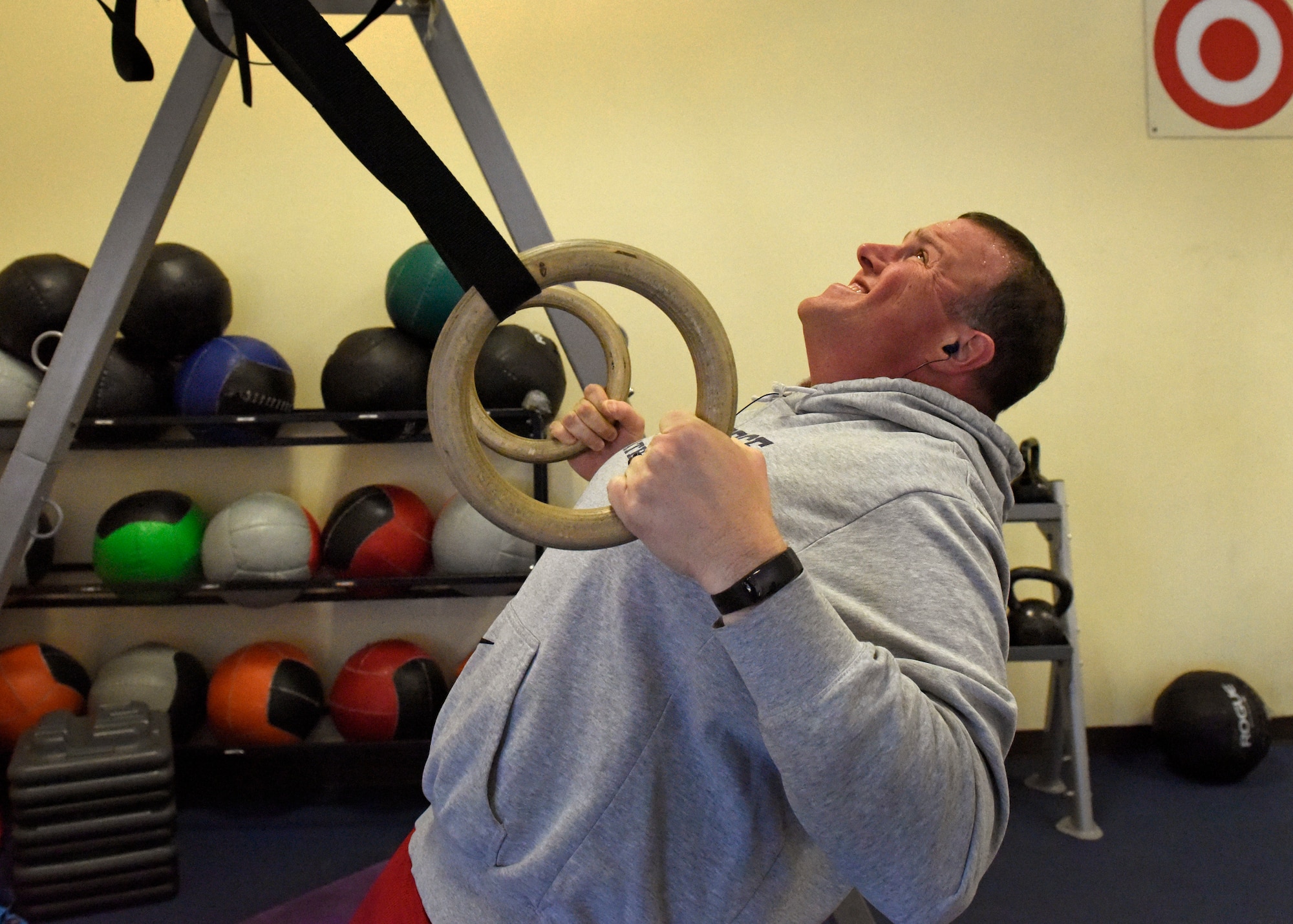 Master Sgt. Shawn Merritt, 92nd Aircraft Maintenance Squadron Human Performance Cell patient, performs inverted rows on rings at Fairchild Air Force Base, Washington, Feb. 26, 2018. In January, the 92nd Medical Group started HPC to aid in the full-spectrum of Airmen readiness. HPC is a multi-disciplinary medical specialist team designed to deliver one-on-one, personalized care to address specific physical demands that Airmen may face using a proactive approach. (U.S. Air Force photo/Airman 1st Class Jesenia Landaverde)