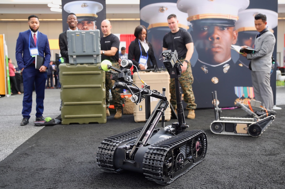 Explosive Ordnance Disposal (EOD) Marines teach engineering students about the MK-2 Mod 1 Talon robot used in improvised explosive device (IED) detection during the National Society of Black Engineers (NSBE) 44th Annual National Convention at the David L. Lawrence Convention Center in Pittsburgh, March 22. During the convention, the Marines participated in the two-day Career Fair, NSBEFit: Body, Mind and Soul, Chapter Officer's Leadership Breakfast and a Wake Up and Workout. The partnership between the Marines and NSBE is intended to increase awareness of Marine Corps career opportunities within the African American community and create an opportunity for Marine Corps personnel to connect and build lasting relationships with conference attendees. (U.S. Marine Corps photo by Sgt. Courtney G. White)