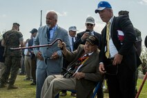 Retired Marine Cpl. Samuel “Lee” Anderson, a former member of the 5th Marine Division, points at the place he landed on the beach 73 years ago from atop Mount Suribachi March 24, 2018 on Iwo To, Japan. Anderson, who enlisted in the Marine Corps in 1943 at 17 years old and landed on the beaches of Iwo Jima at 19 years old as a corporal, returned to the island to participate in the 73rd Reunion of Honor.  Anderson is a native of Venice, California. (U.S. Marine Corps photo by Lance Cpl. Jamin M. Powell)