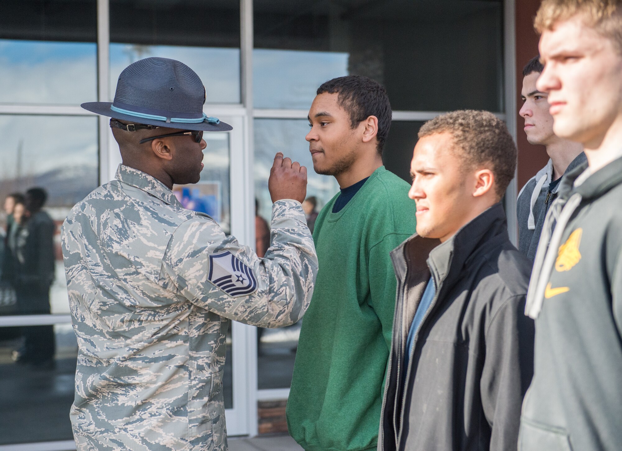 U.S. Air Force Master Sgt. Alonso Blackman, 673d Medical Support Squadron transfusion services section chief and a former basic training military training instructor, gives future Airmen a taste of basic military training in Anchorage, Alaska, March 13, 2018. Blackman taught the recruits the basics of drill, military bearing, dress and appearance, and reporting statements.