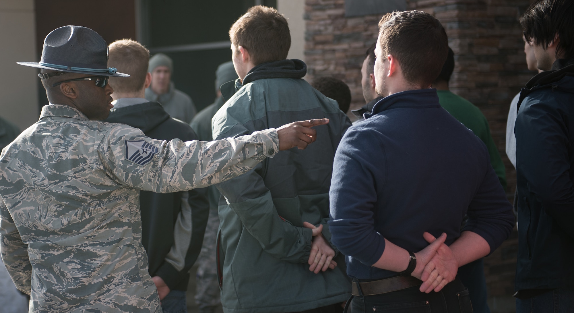 U.S. Air Force Master Sgt. Alonso Blackman, 673d Medical Support Squadron transfusion services section chief and a former basic training military training instructor, gives future Airmen a taste of basic military training in Anchorage, Alaska, March 13, 2018. Blackman taught the recruits the basics of drill, military bearing, dress and appearance, and reporting statements.