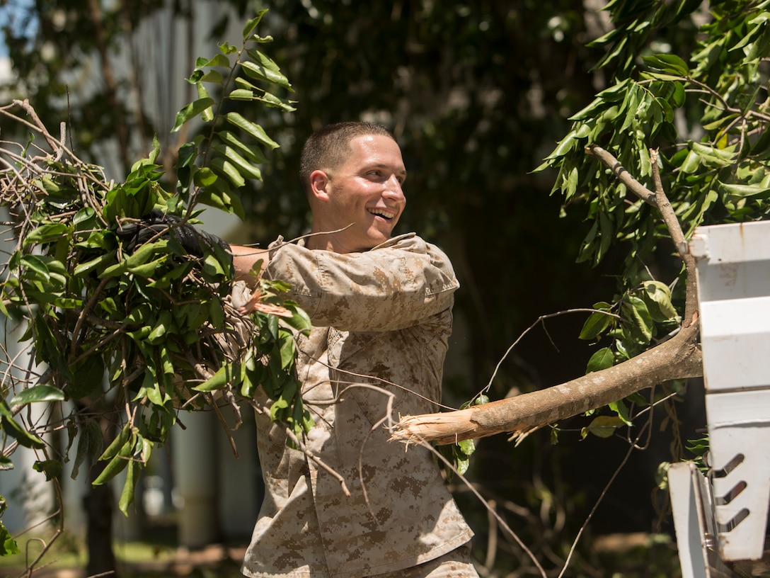 U.S. Marine Corps Sgt. Jonathan Peloquin, an ammunitions chief with Marine Rotational Force (MRF) Darwin (advance party), places branches in the back of a truck at Larrakeyah Defence Precinct, Darwin, NT, Australia March 18, 2018. Marines and Australian Defence Force service members aided in cleaning up debris found throughout the installation after Tropical Cyclone Marcus swept across parts of the northern coast of Australia. The Marines are part of an advanced echelon preparing for MRF-D. (U.S. Marine Corps photos by Lance Cpl. Mason Roy)