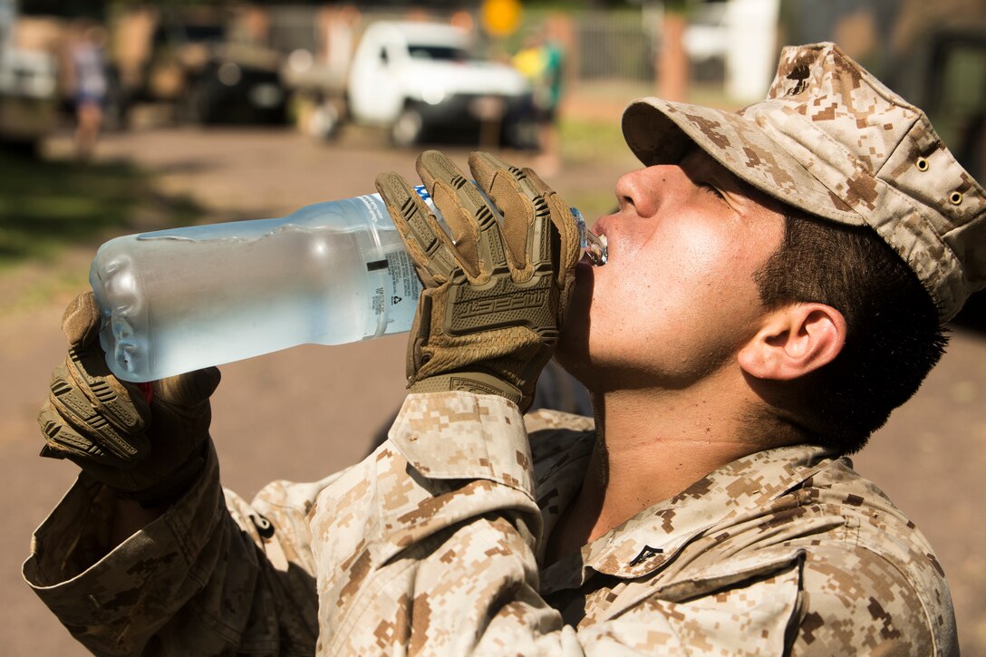 A U.S. Marine with Marine Rotational Force (MRF) Darwin, GESP, hydrates after clearing debris at Darwin, NT, Australia March 20, 2018. Approximately 45 Marines and 300 Australian Defence Force service members helped clear road and pathways around the Darwin area. The relief efforts arose after Tropical Cyclone Marcus, category 2, swept through coastal parts of the Northern Territory. (U.S. Marine Corps photo by Lance Cpl. Mason Roy)