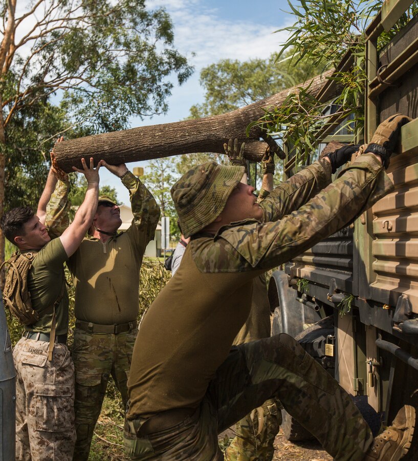U.S. Marines and Australian Defence Force service members assist in clearing debris at Darwin, NT, Australia March 20, 2018. Approximately 45 Marines and 300 Australian Defence Force service members helped clear road and pathways around the Darwin area. The relief efforts arose after Tropical Cyclone Marcus, category 2, swept through coastal parts of the Northern Territory. (U.S. Marine Corps photo by Lance Cpl. Mason Roy)