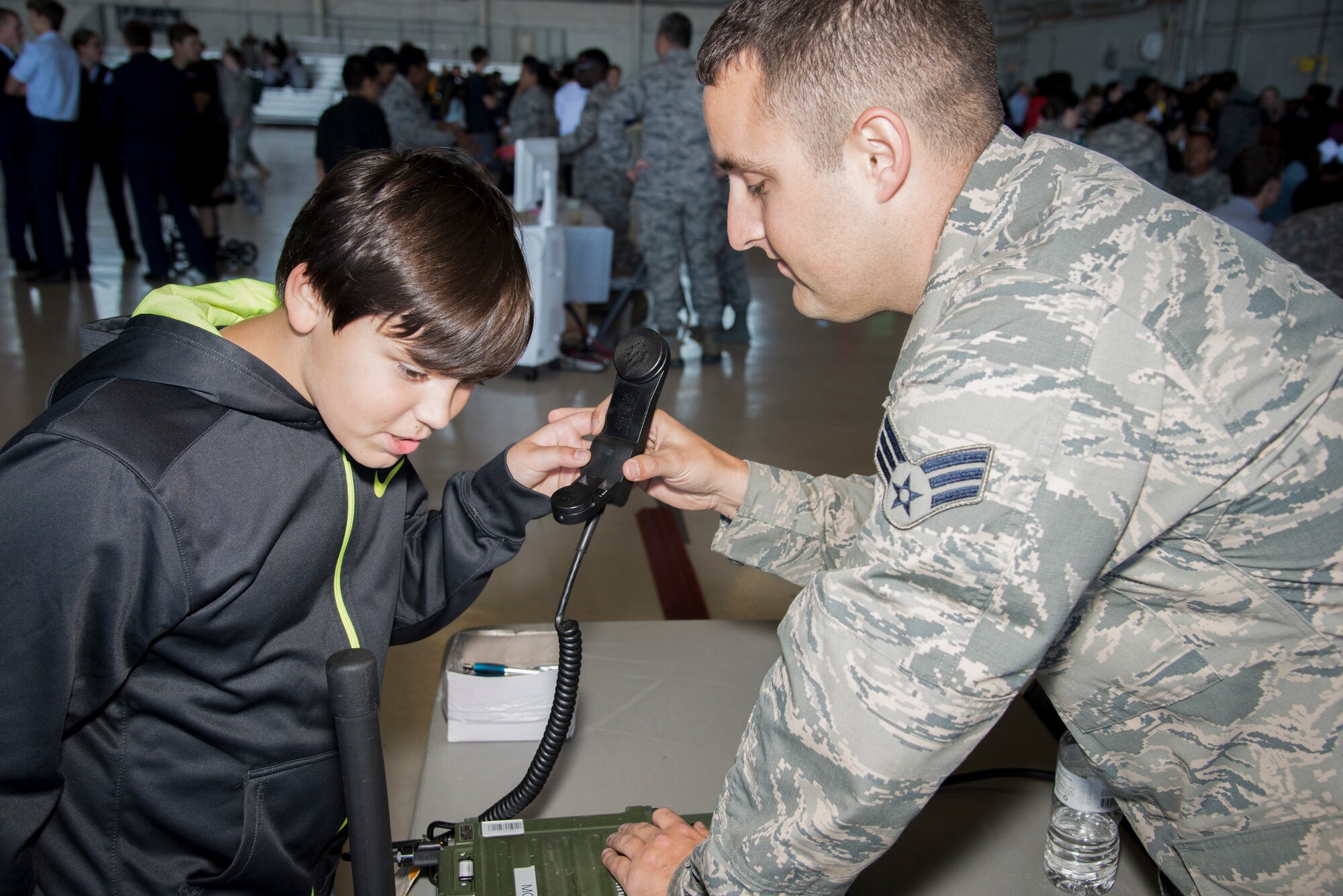 U.S. Air Force Senior Airman David Hamilton, a radio frequency transmission technician assigned to 6th Communication Squadron, demonstrates the use of a land mobile radio system during the Science, Technology, Engineering, Arts and Math (STEAM) Day at MacDill Air Force Base, Fla., March 21, 2018.