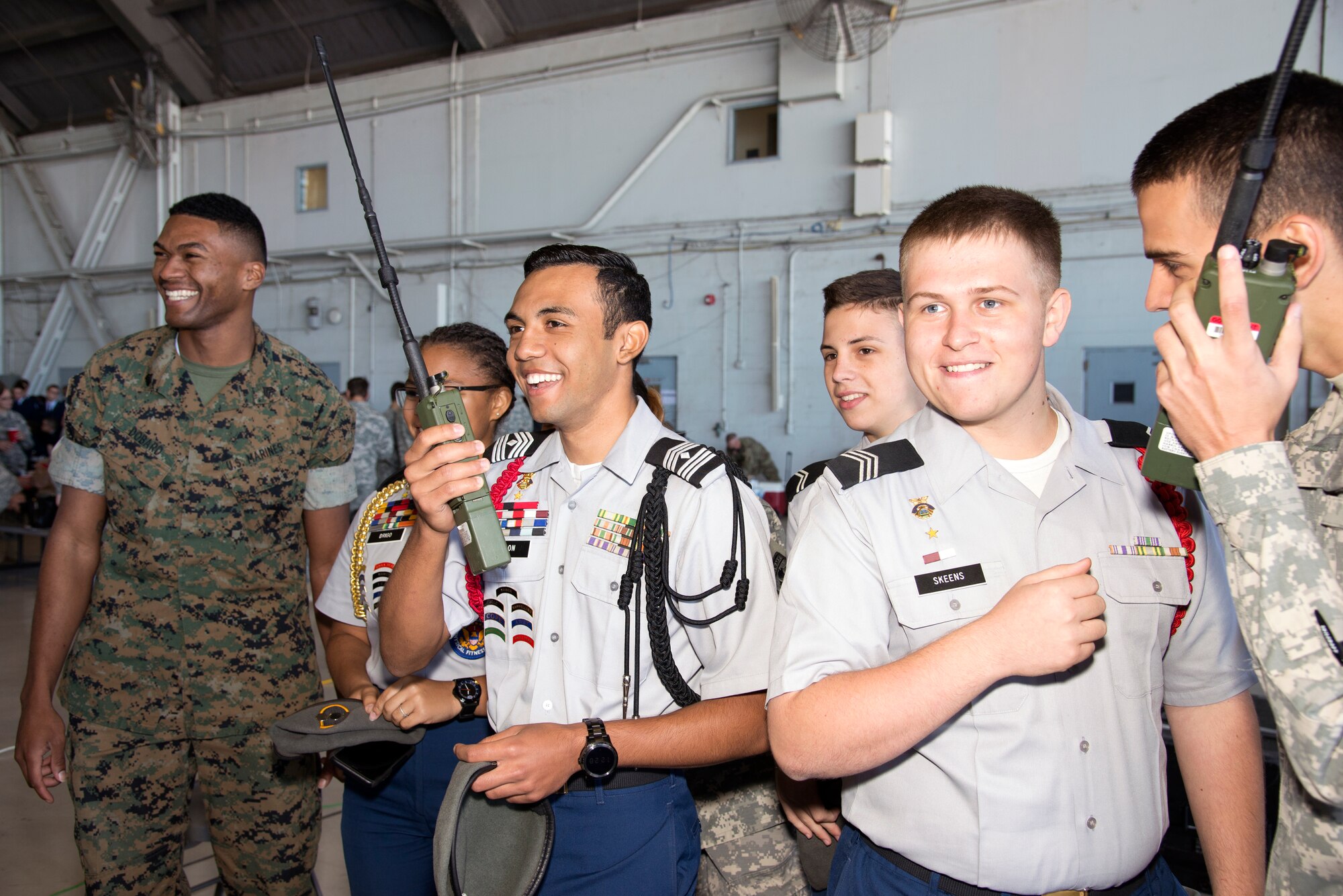 U.S. Marine Sgt. Christopher Dobard, a team chief assigned to Joint Communications Support Element, laughs with students while communicating through a multiband multi mission radio during the Science, Technology, Engineering, Arts and Math (STEAM) Day at MacDill Air Force Base, Fla., March 21, 2018.