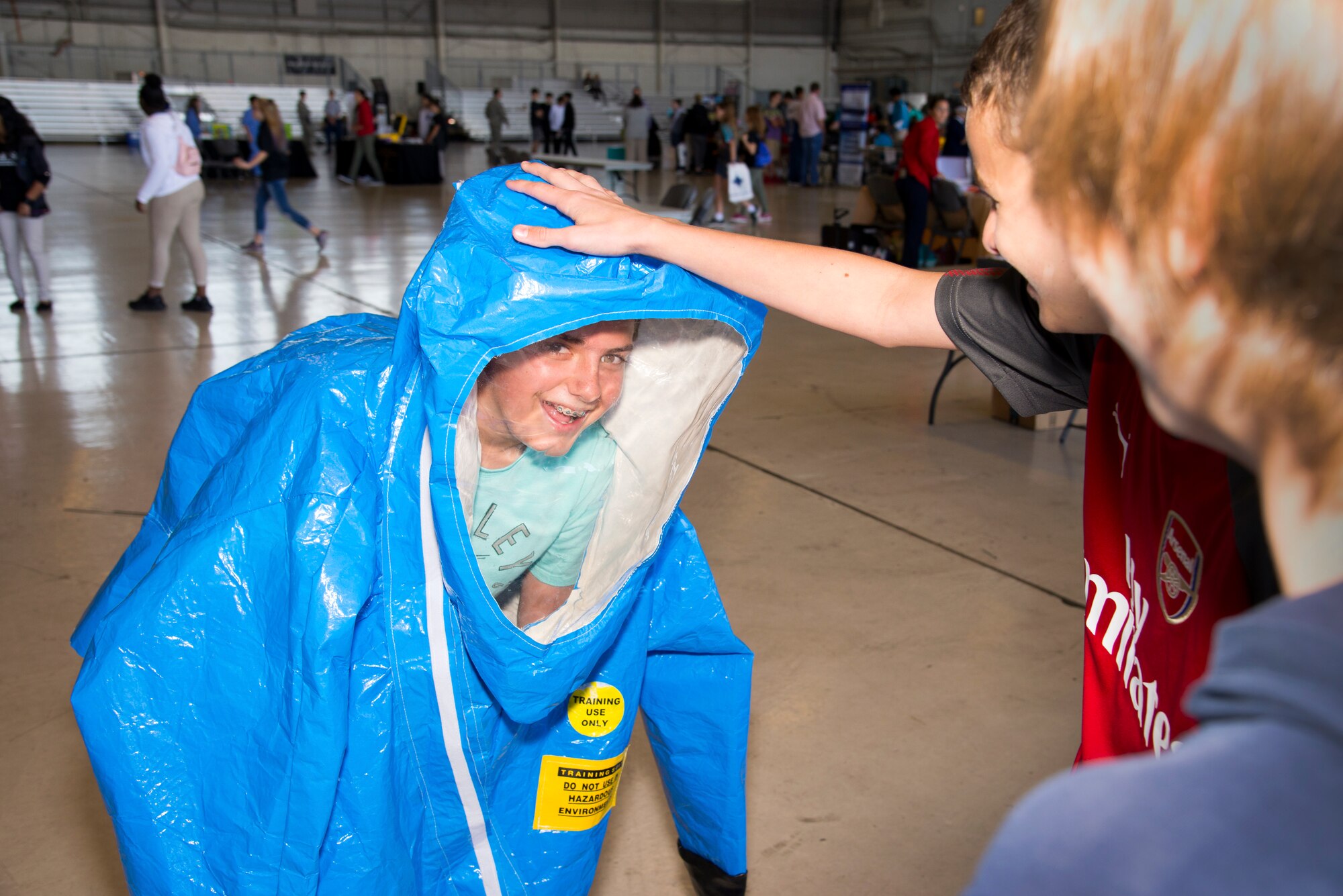 A Florida student tries on an occupational safety health administration (OSHA) level “A” suit during the Science, Technology, Engineering, Arts and Math (STEAM) Day at MacDill Air Force Base, Fla., March 21, 2018.