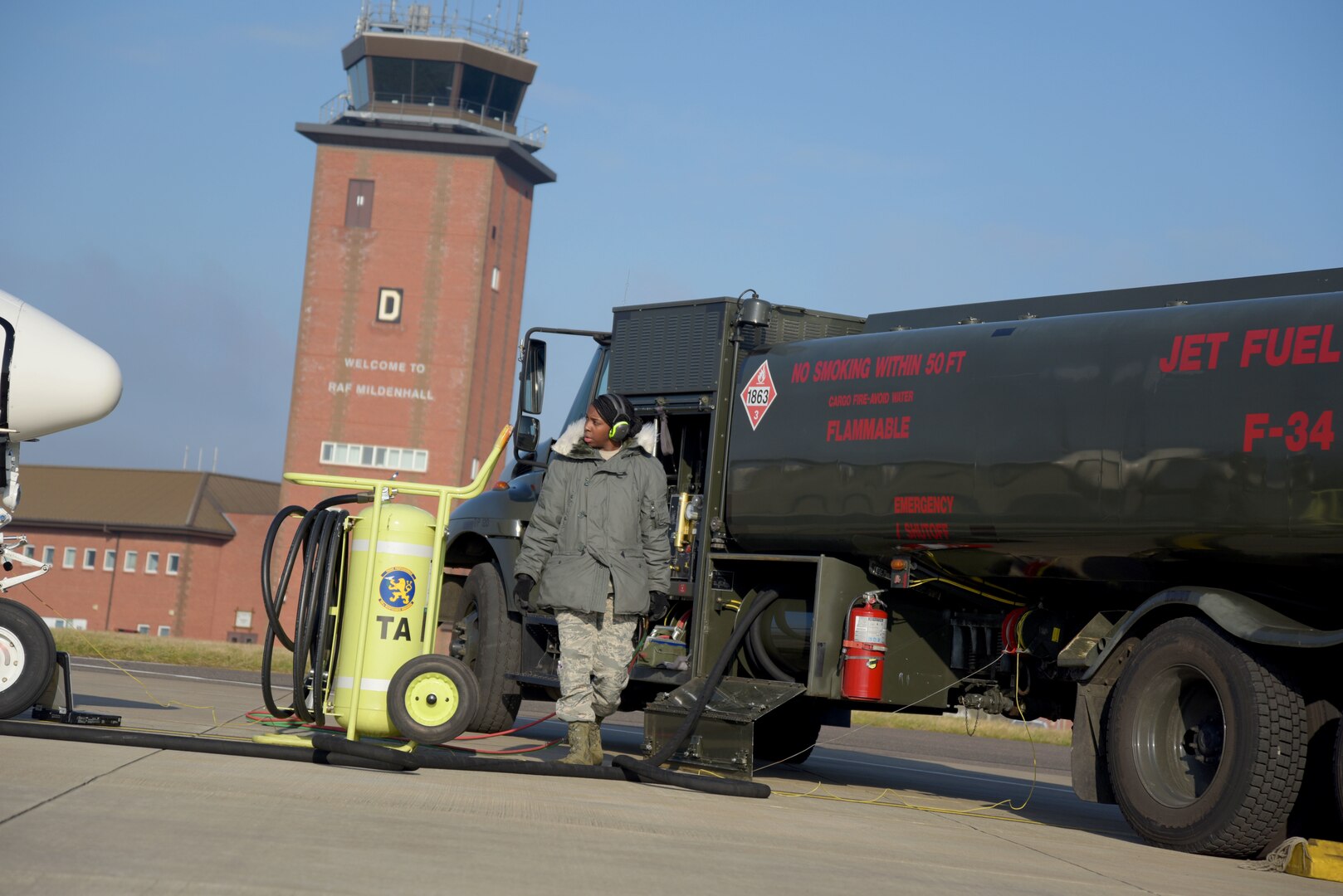 U.S Air Force Airman 1st Class Aaliyah Tucker, 100th Logistics Readiness Squadron petroleum, oil and lubricant fuels distributor poses while pumping a R-11 fuel truck at RAF Mildenhall, England, Jan. 21, 2018. Checks are performed every morning on the trucks, to ensure the lights, the fuels and the sensors are all working properly. (U.S. Air Force photo by Airman 1st Class Alexandria Lee)