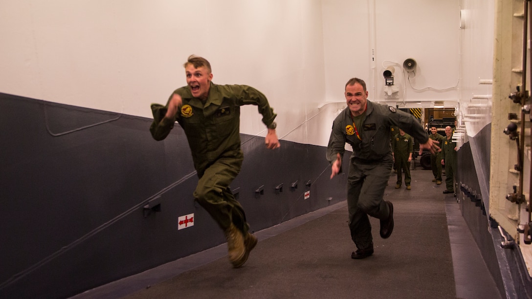 Lt. Col. Kyle Shoop, commanding officer, Marine Fighter Attack Squadron-211, 13th Marine Expeditionary Unit, and Cpl. Garrett Ross (left), plane captain, VMFA-211, 13th MEU, compete in a race during a unit competition, March 25, 2018. “Besides the obvious benefit of a good workout, these little competitions are amazing for the unit’s morale as a whole,” Shoop said. The Wasp-class mphibious ship USS Essex (LHD 2) and 13th Marine Expeditionary Unit fully integrated for the first time before their summer deployment. Anphibious Squadron, MEU integration training is a crucial pre-deployment exercise that allows the Navy-Marine Corps team to rapidly plan and execute complex operations from naval shipping.